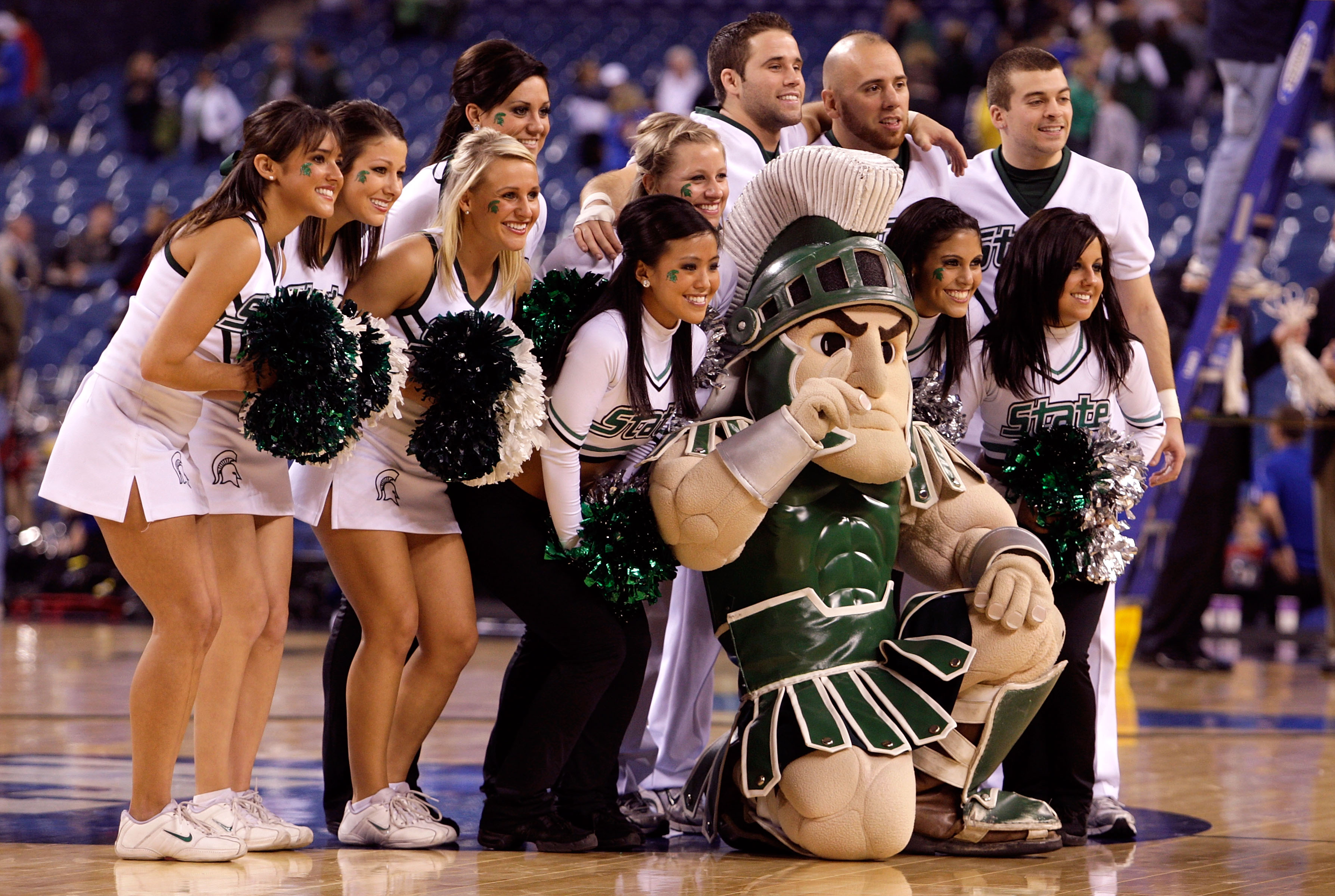 INDIANAPOLIS - MARCH 27:  Sparty the mascot of the Michigan State Spartans poses for a photo with the cheerleaders against the Kansas Jayhawks during the third round of the NCAA Division I Men's Basketball Tournament at the Lucas Oil Stadium on March 27,