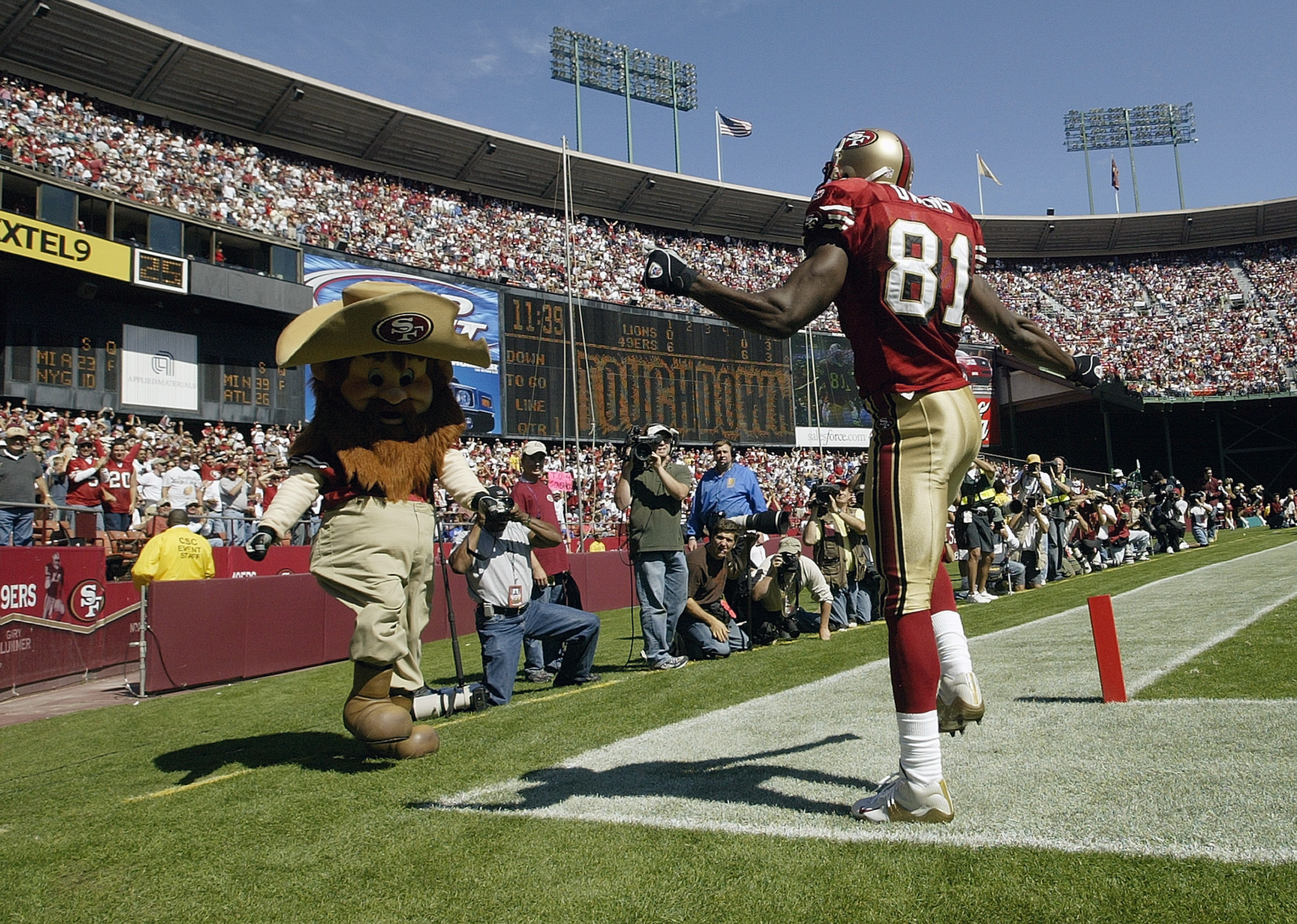 SAN FRANCISCO - OCTOBER 5:  Wide receiver Terrell Owens #81 of the San Francisco 49ers does a dance with 'Sourdough Sam' to celebrate his touchdown catch against the Detroit Lions on October 5, 2003 at 3 Com Park in San Francisco, California.  The 49ers d