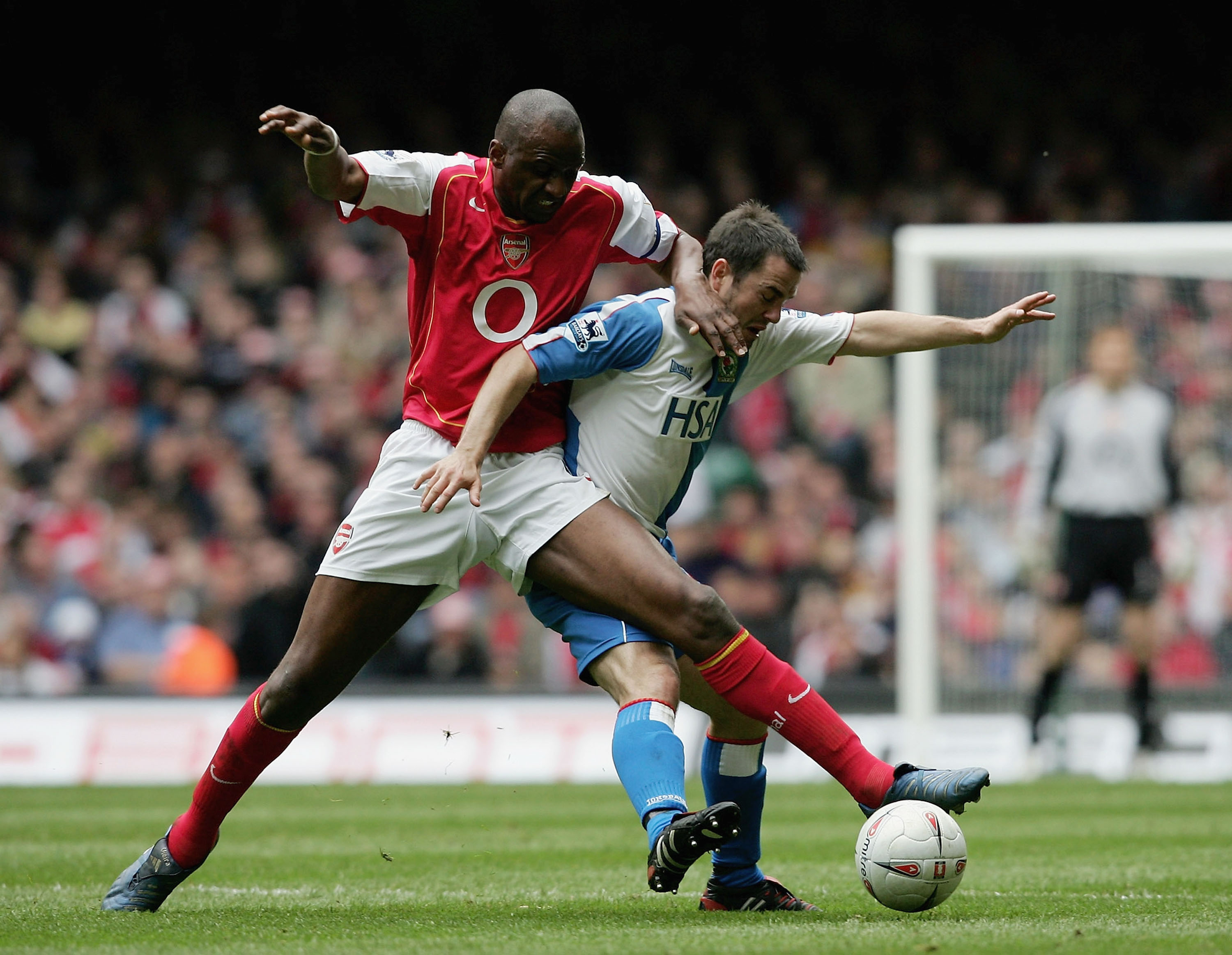 Arsenal's Nicolas Anelka evades a tackle from West Ham United's