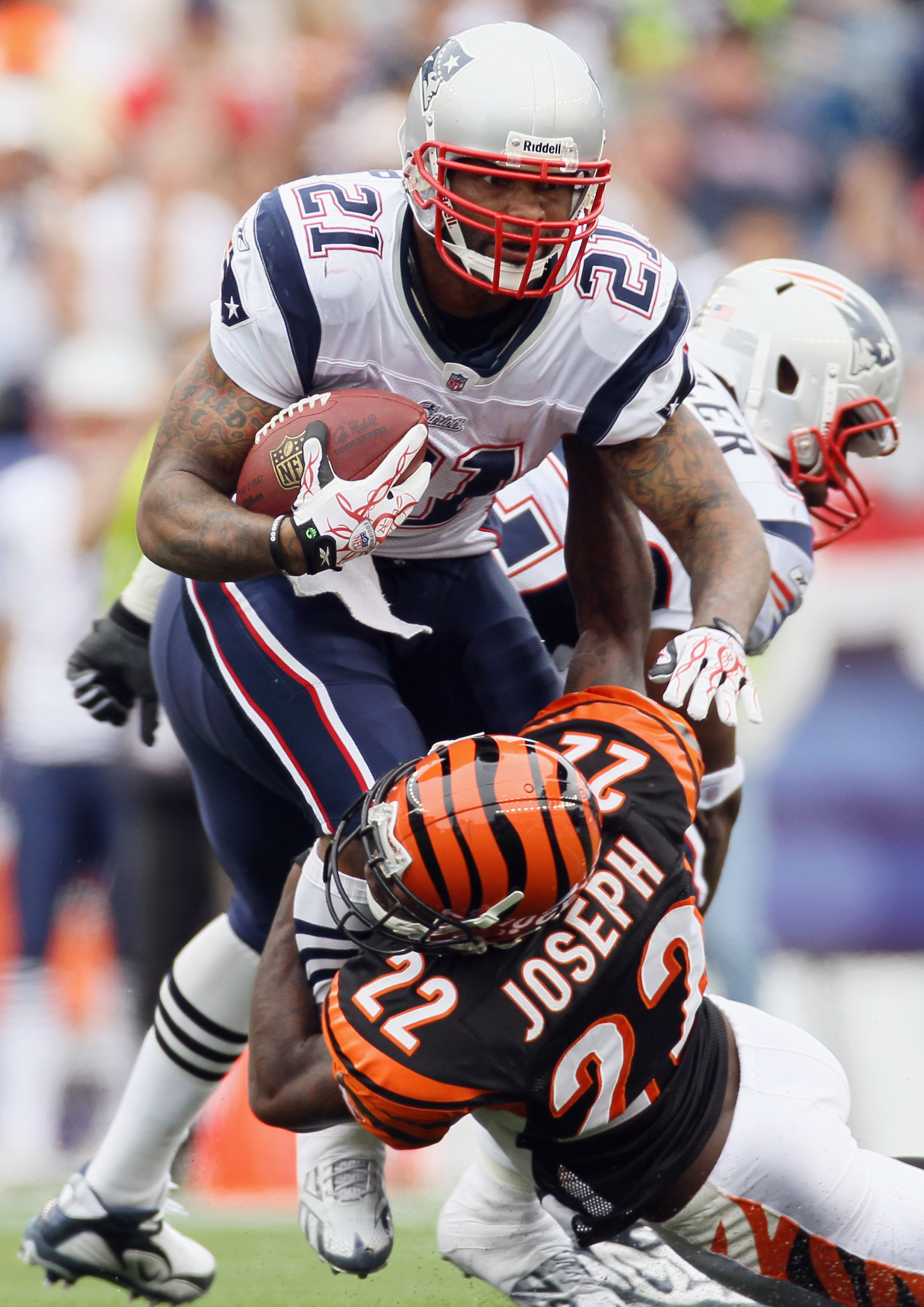 FOXBORO, MA - SEPTEMBER 12:  Fred Taylor #21 of the New England Patriots is tackled by Johnathan Joseph #22 of the Cincinnati Bengals during the NFL season opener on September 12, 2010 at Gillette Stadium in Foxboro, Massachusetts. The Patriots defeated t