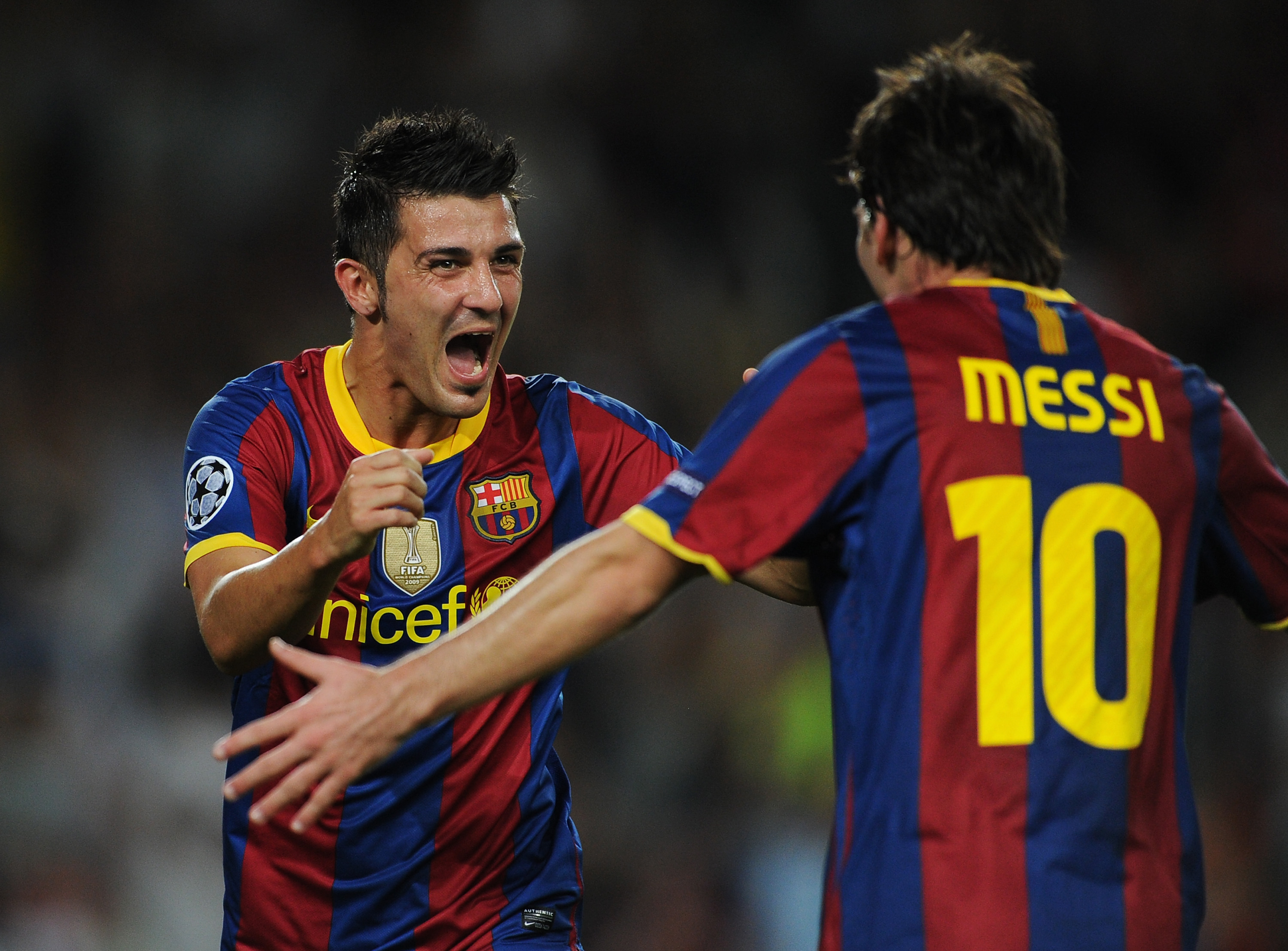 BARCELONA, SPAIN - SEPTEMBER 14:  David Villa (L) of Barcelona celebrates scoring his sides second goal with his teammate Lionel Messi during the UEFA Champions League group D match between Barcelona and Panathinaikos on September 14, 2010 in Barcelona, S