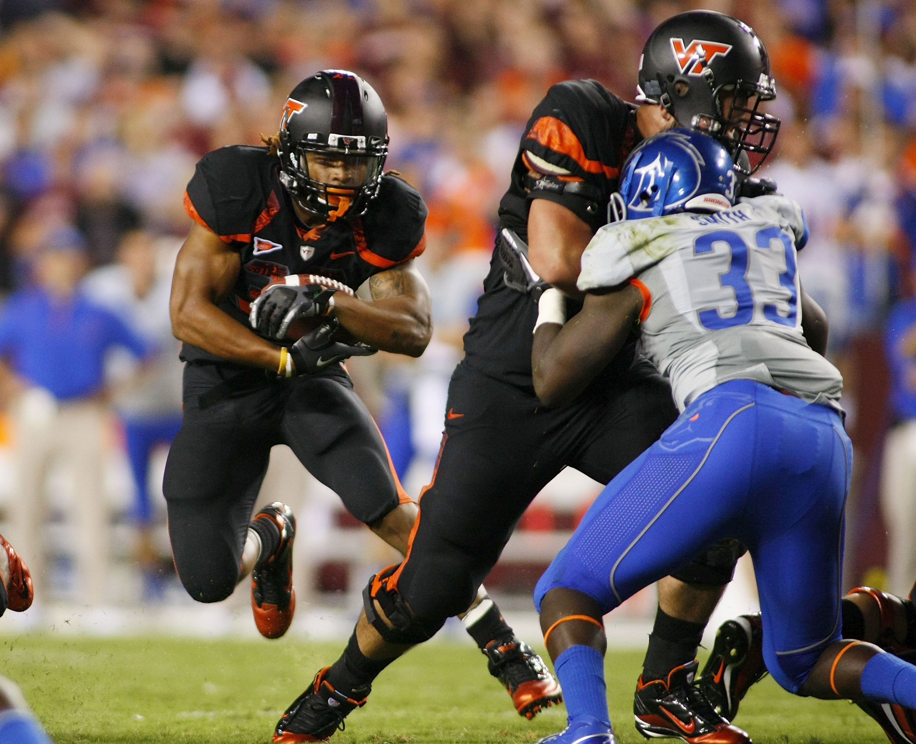 LANDOVER, MD - SEPTEMBER 06: Running back Darren Evans #32 of the Virginia Tech Hokies runs past linebacker Tommy Smith #33 of the Boise State Broncos at FedExField on September 6, 2010 in Landover, Maryland. (Photo by Geoff Burke/Getty Images)