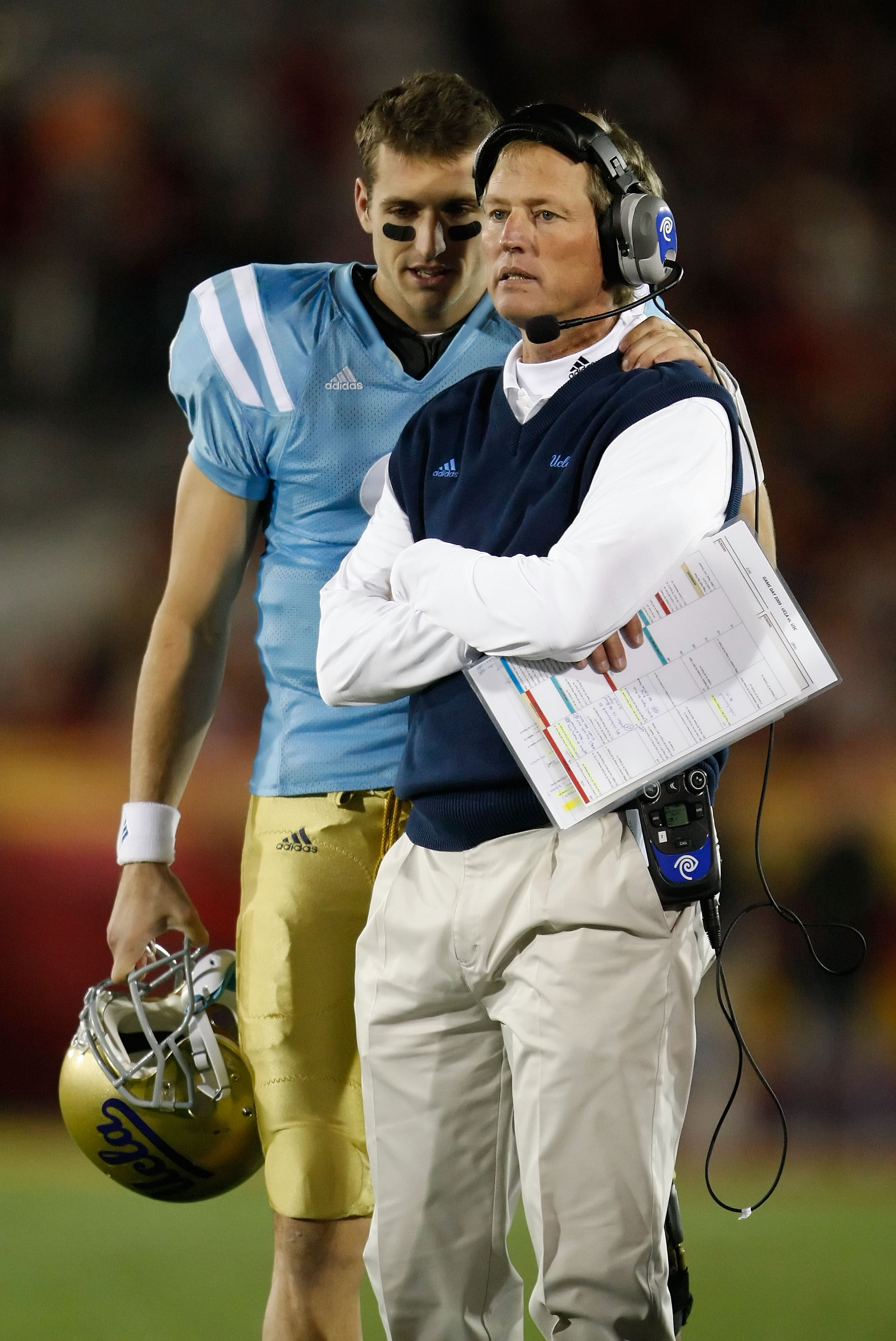 LOS ANGELES, CA - NOVEMBER 28: Kevin Craft #3 speaks with UCLA Bruins head coach Rick Neuheisel in the second half against the USC Trojans at the Los Angeles Memorial Coliseum on November 28, 2009 in Los Angeles, California. USC defeated UCLA 28-7. (Pho
