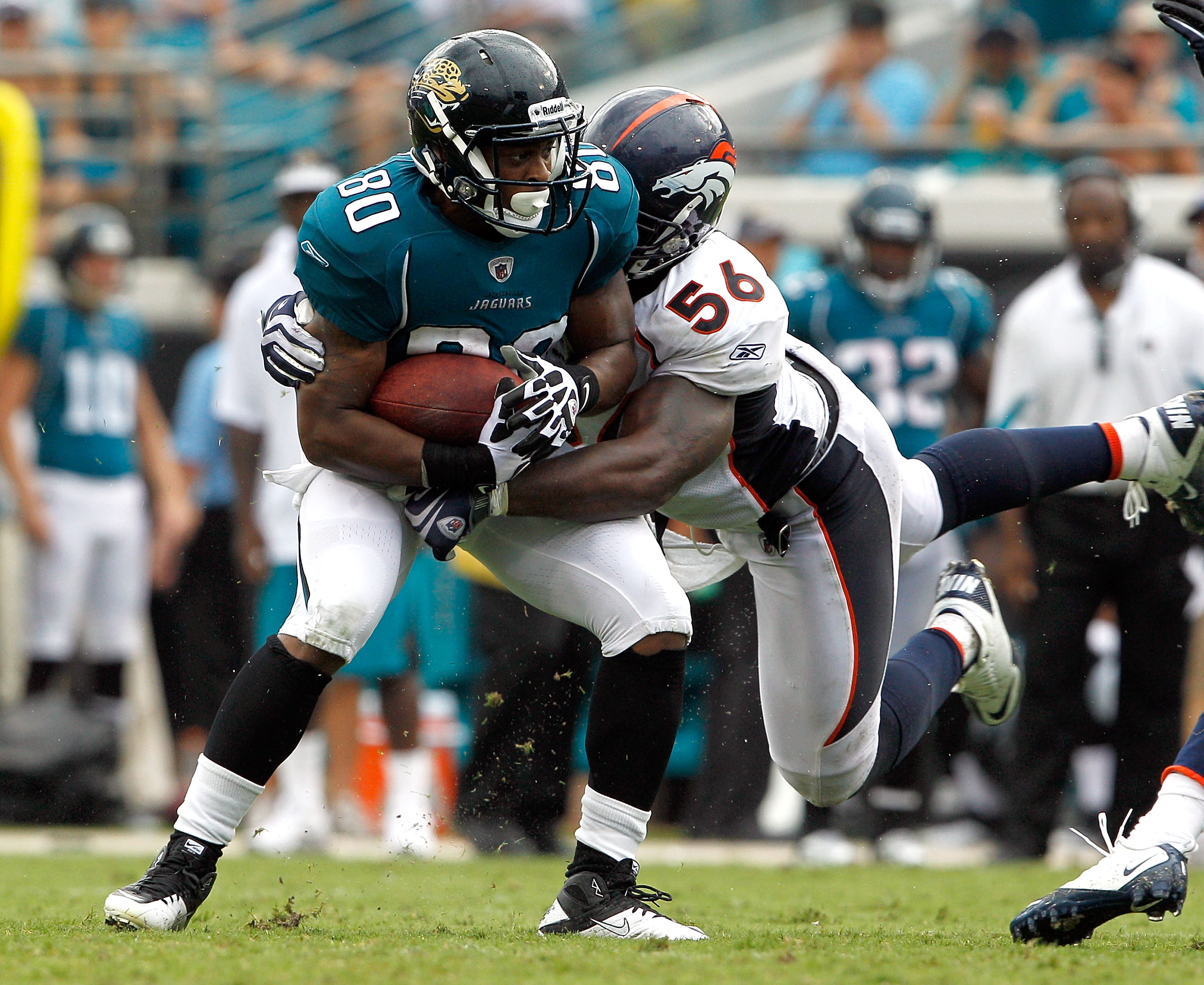 JACKSONVILLE, FL - SEPTEMBER 12:  Robert Ayers #56 of the Denver Broncos attempts to tackle Mike Thomas #80 of the Jacksonville Jaguars during the NFL season opener game at EverBank Field on September 12, 2010 in Jacksonville, Florida.  (Photo by Sam Gree