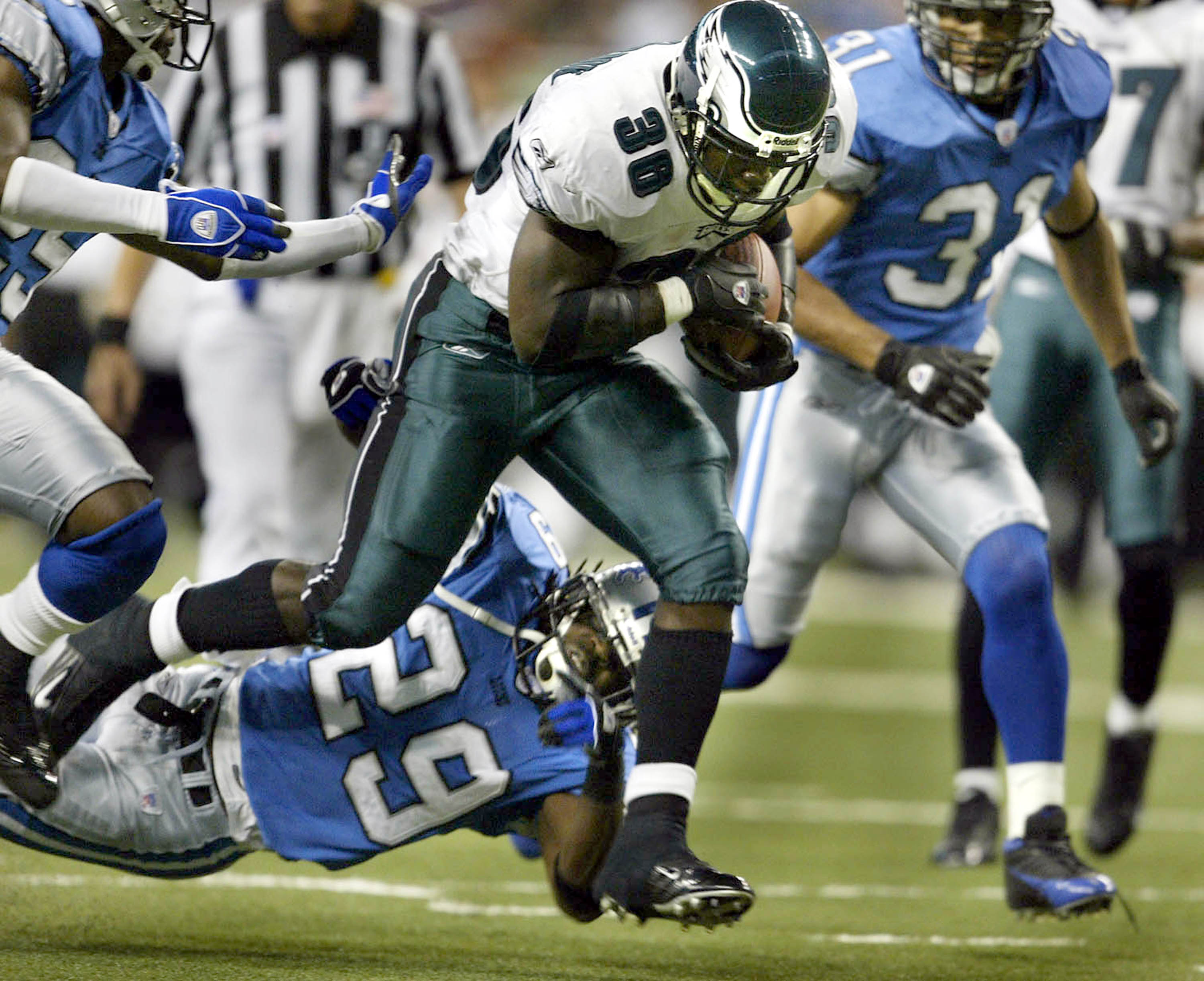 DETROIT - SEPTEMBER 26: Brian Westbrook #36 of the Philadelphia Eagles rushes for a first down defended by Chris Cash #29 of the Detroit Lions in the second quarter at Ford Field on September 26, 2004 in Detroit, Michigan. (Photo by Tom Pidgeon/Getty Imag