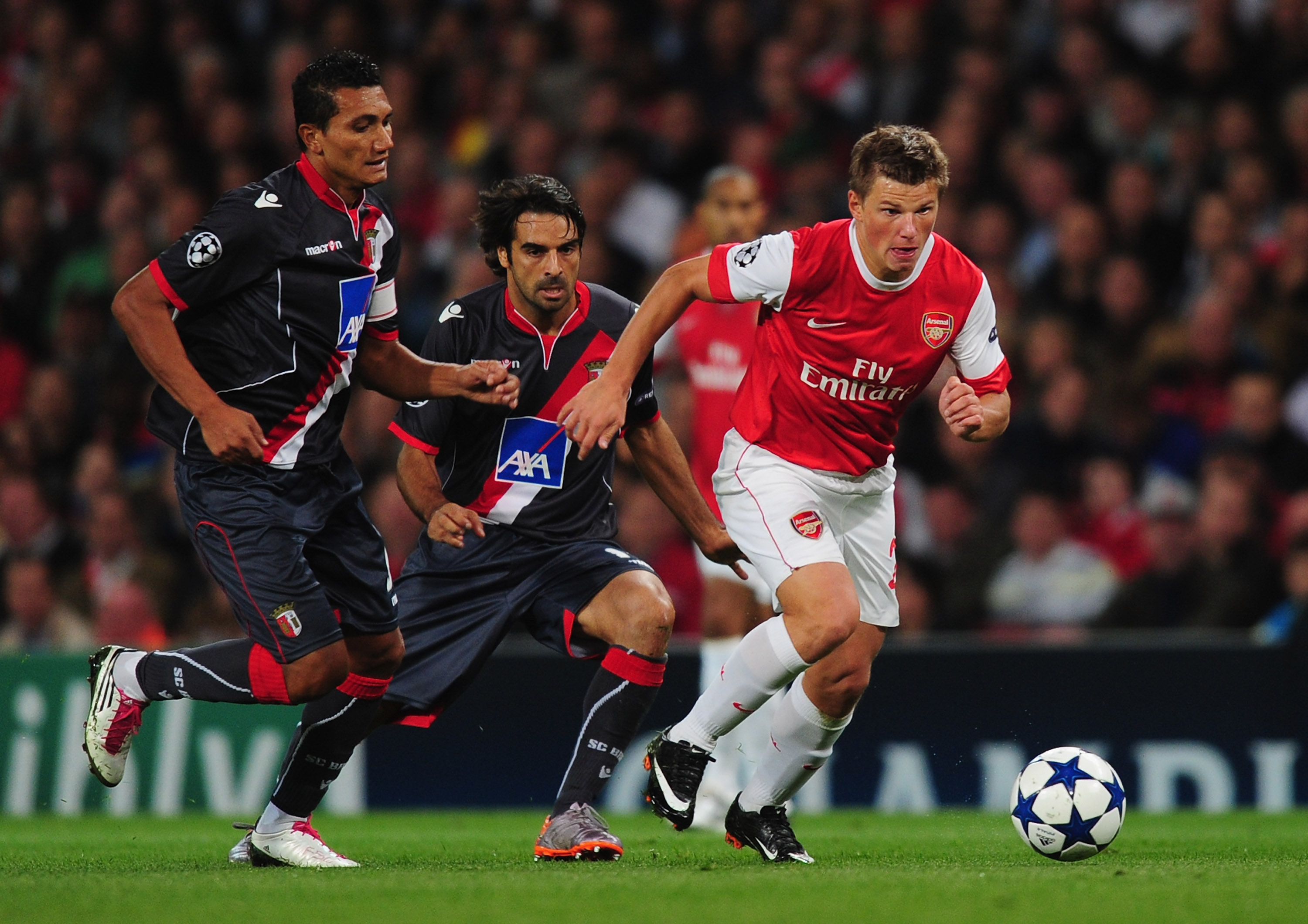 LONDON, ENGLAND - SEPTEMBER 15:  Andrey Arshavin of Arsenal gets away from Vandinho (L) and Miguel Garcia of Braga during the UEFA Champions League Group H match between Arsenal and SC Braga at the Emirates Stadium on September 15, 2010 in London, England