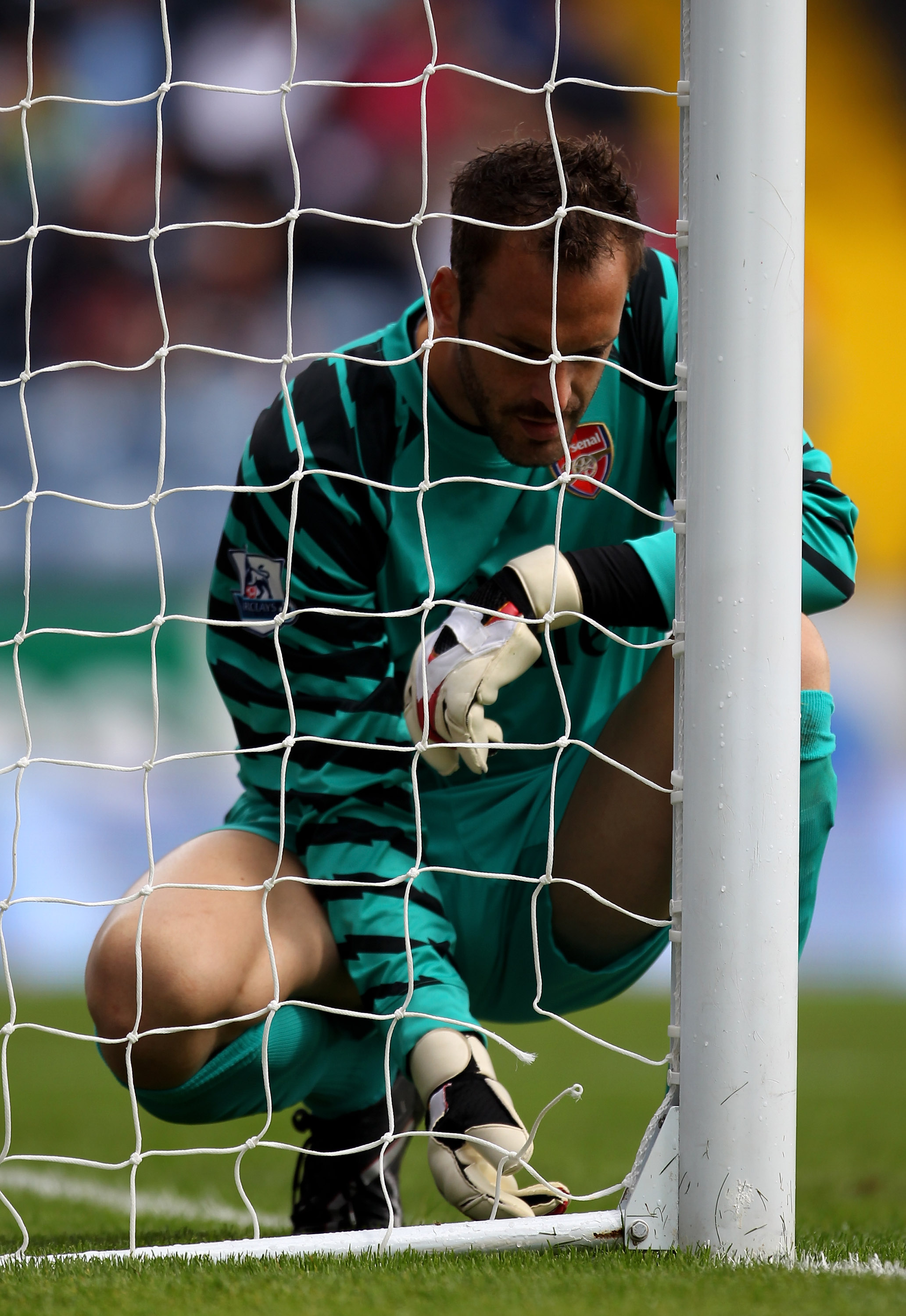 BLACKBURN, ENGLAND - AUGUST 28:  Manuel Almunia of Arsenal inspects the broken net during the Barclays Premier League match between Blackburn Rovers and Arsenal at Ewood Park on August 28, 2010 in Blackburn, England. (Photo by Alex Livesey/Getty Images)