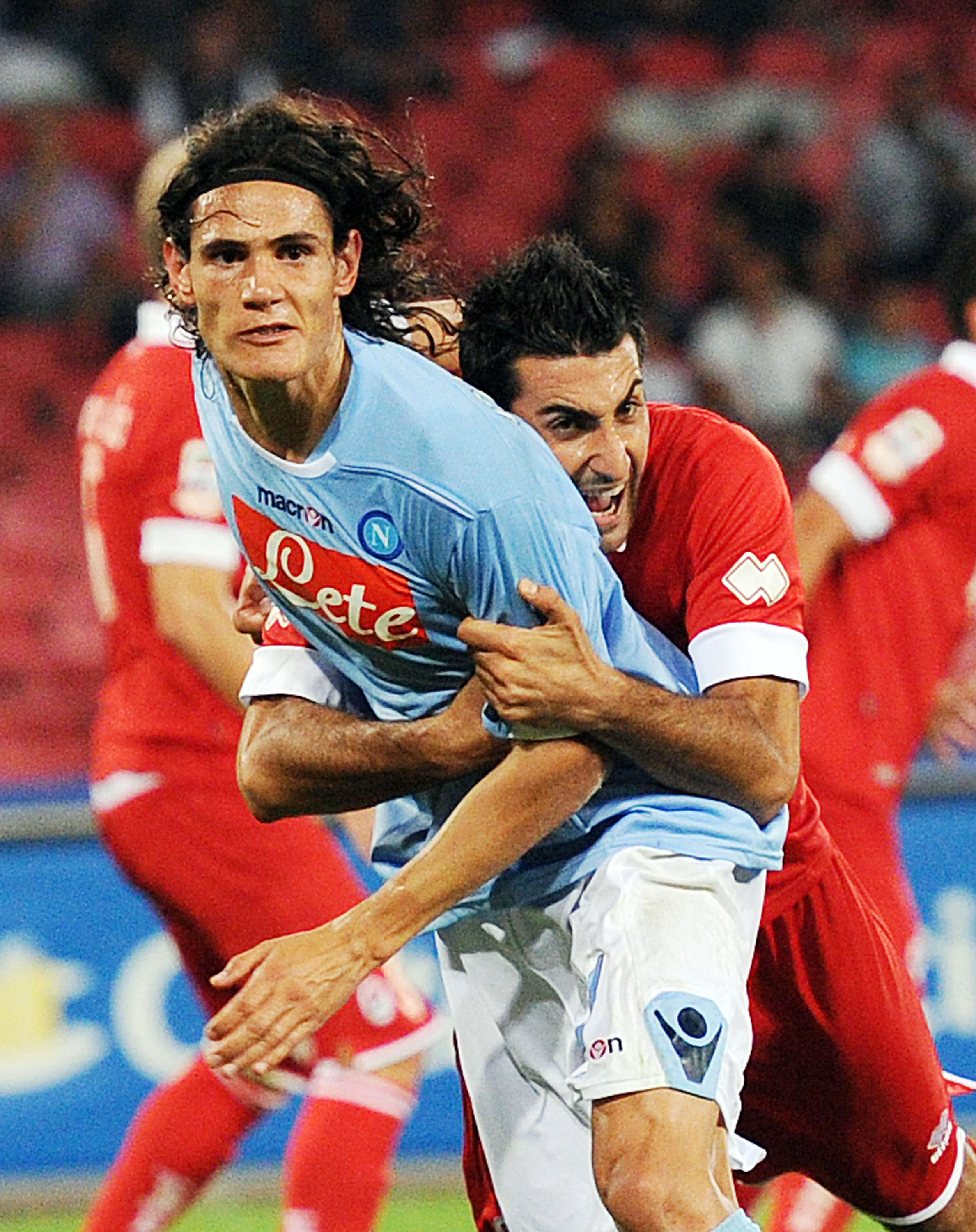 NAPLES, ITALY - SEPTEMBER 12:  Edinson Cavani  of Napoli and Nicola Belmonte of Bari in action  during the Serie A match between Napoli and Bari at Stadio San Paolo on September 12, 2010 in Naples, Italy.  (Photo by Giuseppe Bellini/Getty Images)