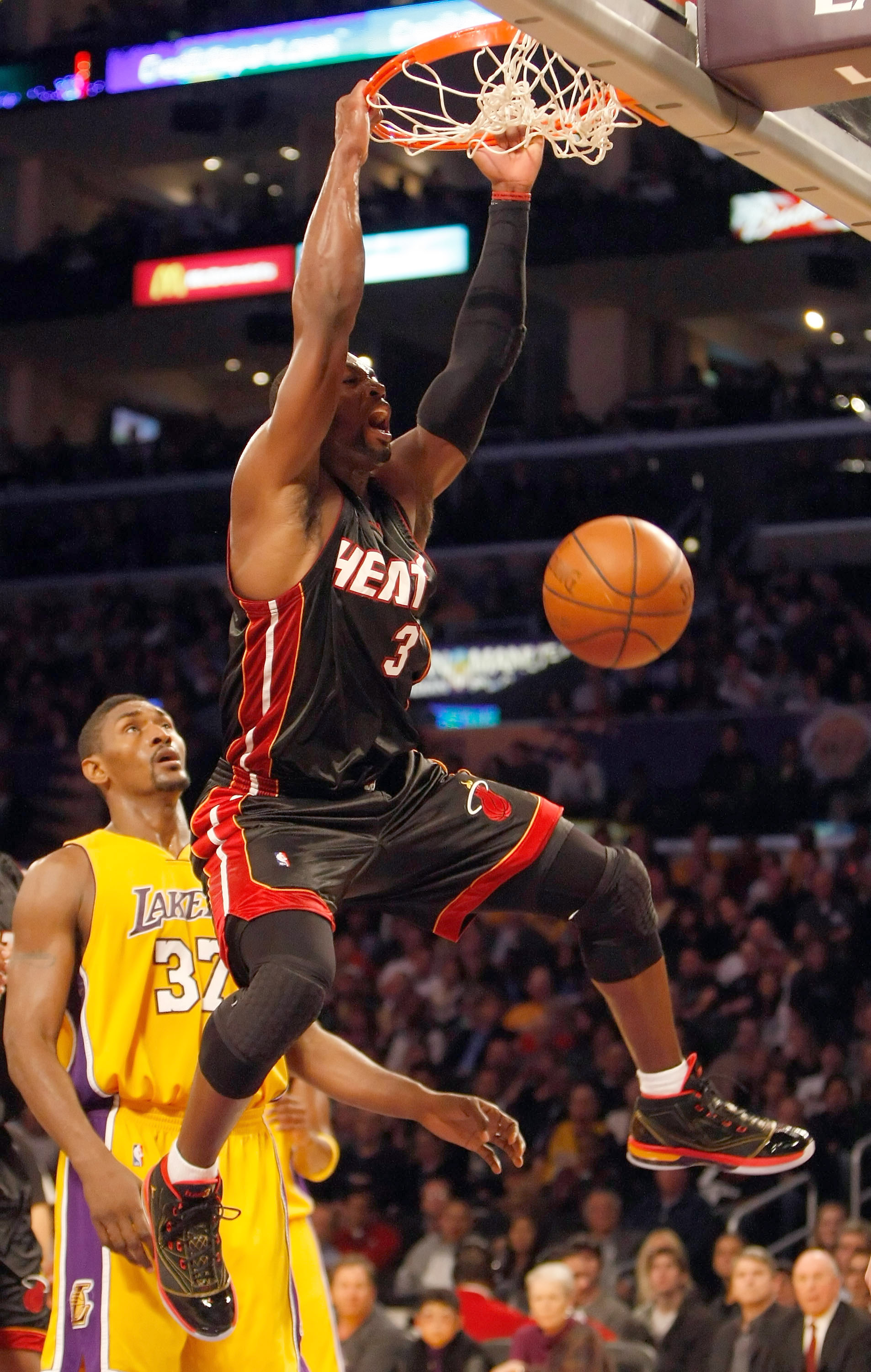 LOS ANGELES, CA - DECEMBER 04:  Dwyane Wade #3 of the Miami Heat dunks the ball in front of Ron Artest #37 of the Los Angeles Lakers in the first half at Staples Center on December 4, 2009 in Los Angeles, California. NOTE TO USER: User expressly acknowled