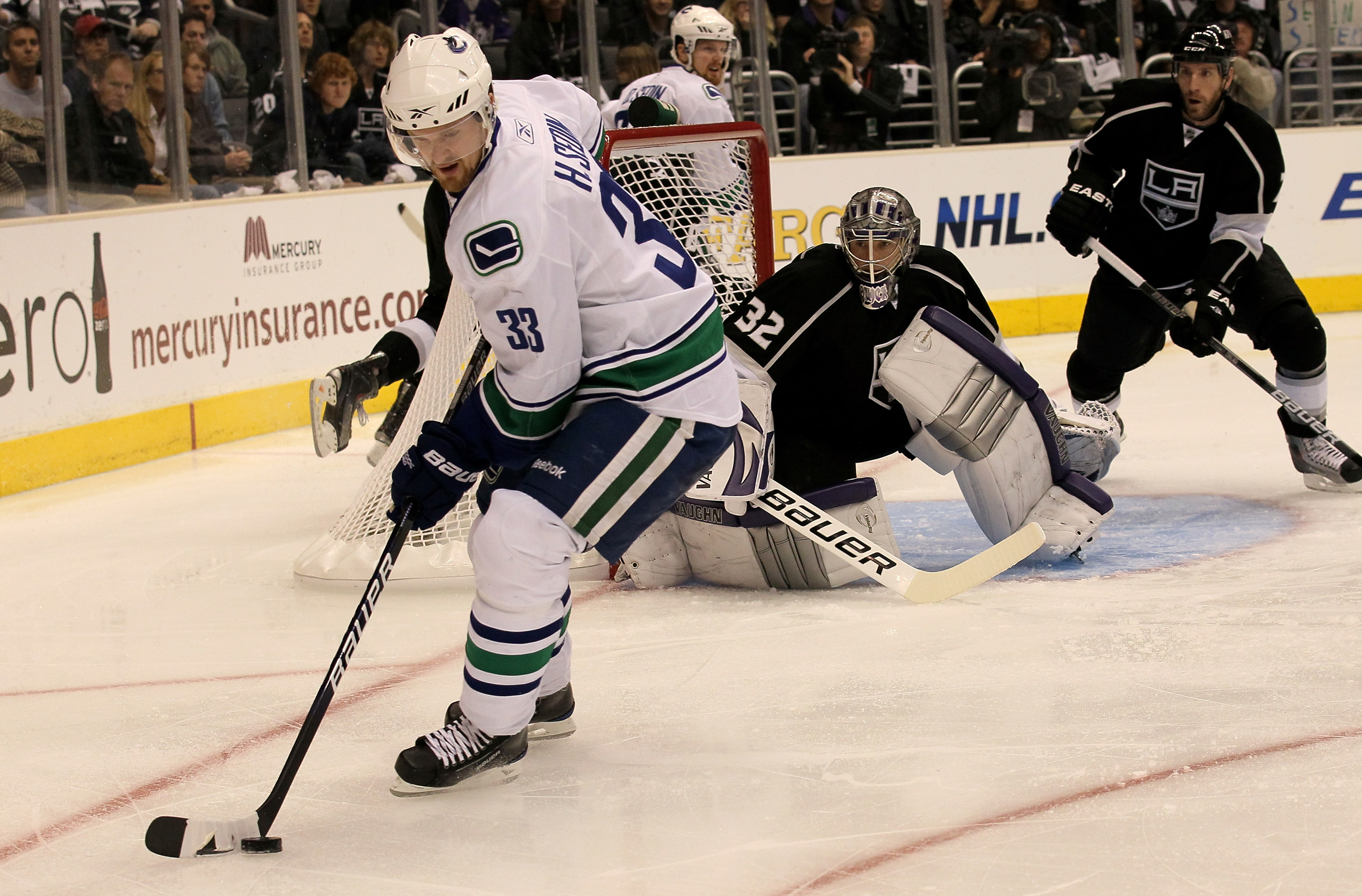 LOS ANGELES - APRIL 25:  Henrik Sedin #33 of the Vancouver Canucks controls the puck in front goaltender Jonathan Quick #32 of the Los Angeles Kings during Game Six of the Western Conference Quarterfinals of the 2010 NHL Stanley Cup Playoffs on April 25, 