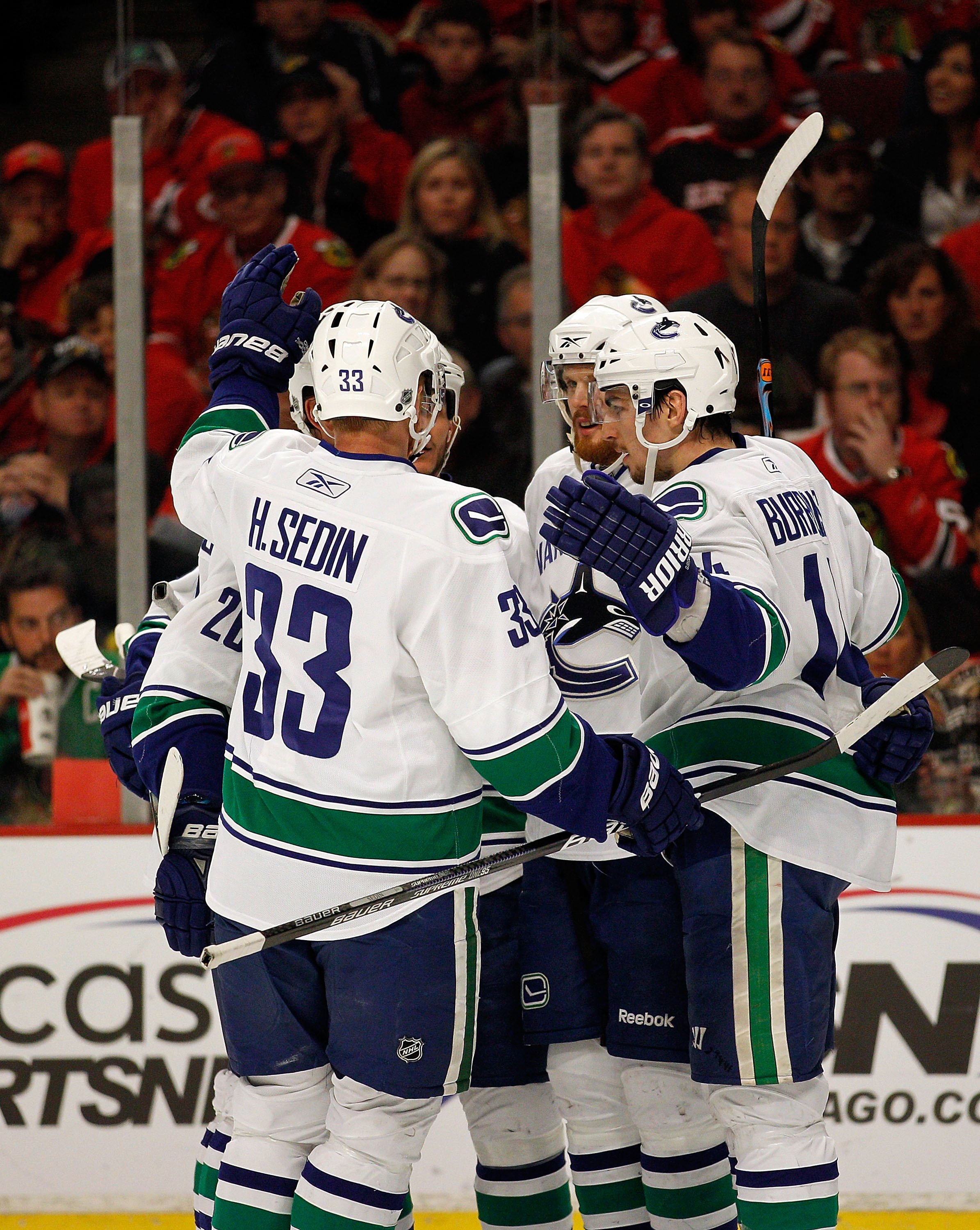 CHICAGO - MAY 09: Members of the Vancouver Canucks including Henrik Sedin #33 and Alexandre Burrows #14 celebrate a 2nd period goal against the Chicago Blackhawks in Game Five of the Western Conference Semifinals during the 2010 NHL Stanley Cup Playoffs a