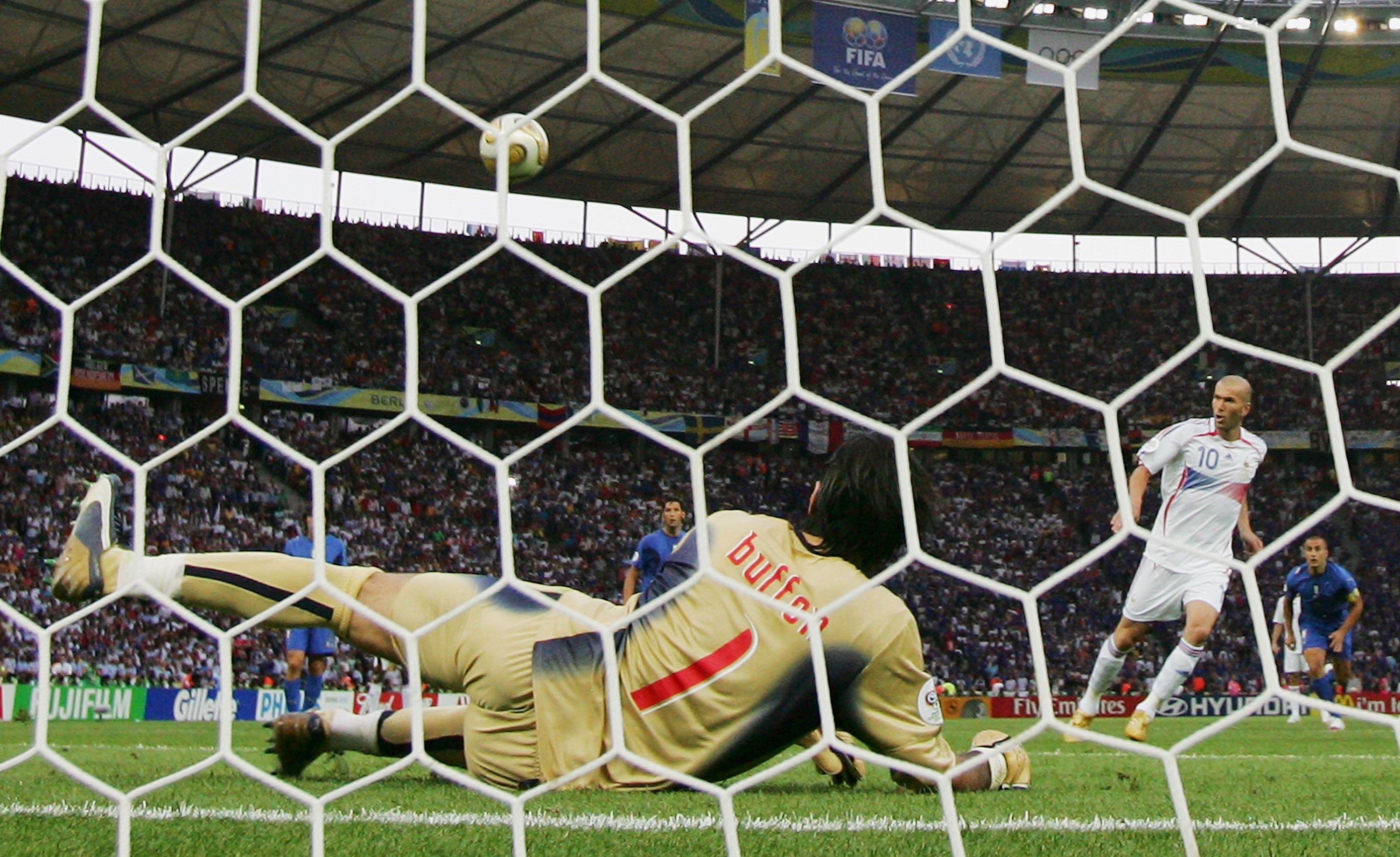 BERLIN - JULY 9:  Zinedine Zidane of France scores the opening goal  from the penalty spot past Goalkeeper Gianluigi Buffon of Italy during the FIFA World Cup Germany 2006 Final match between Italy and France at the Olympic Stadium on July 9, 2006 in Berl