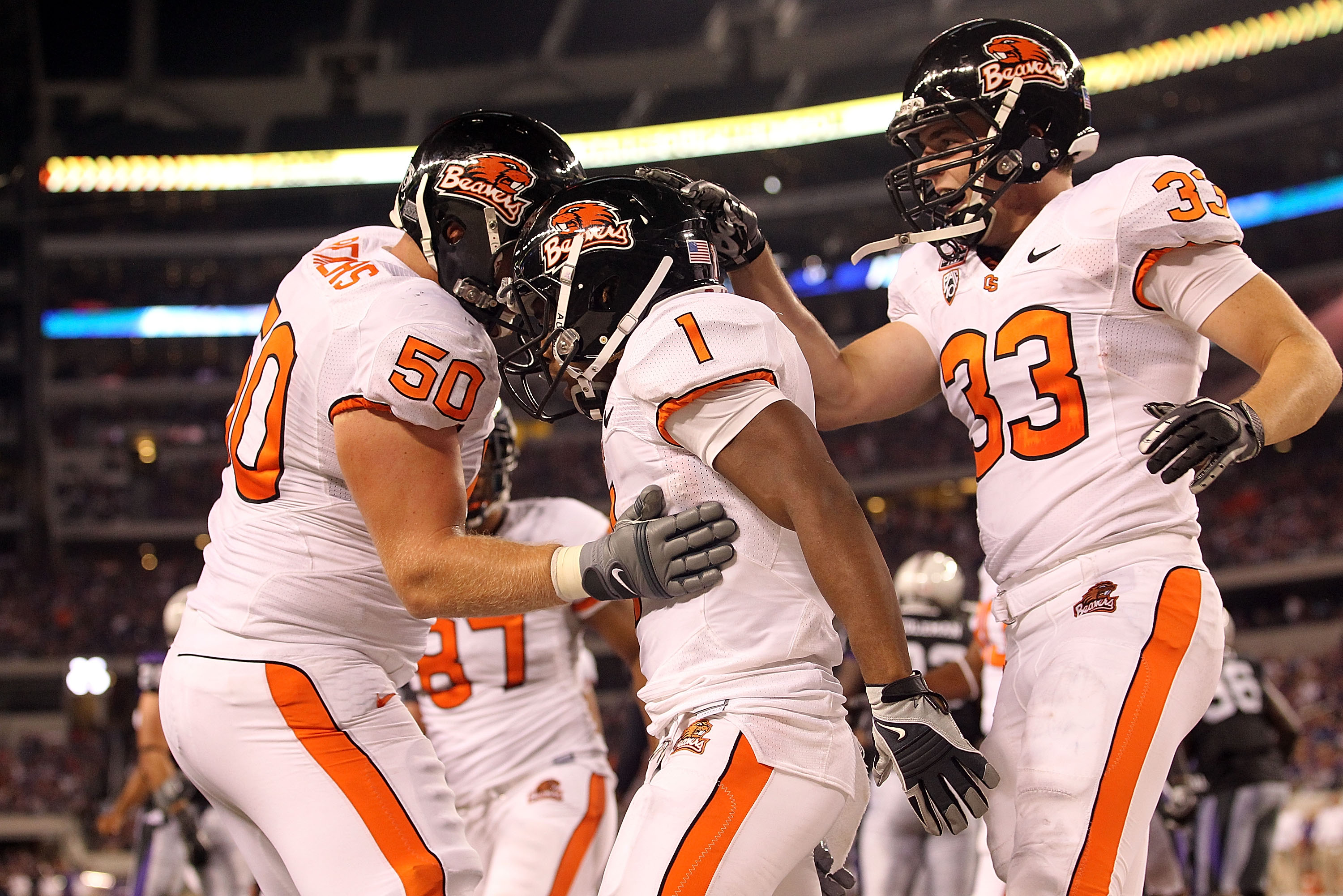 ARLINGTON, TX - SEPTEMBER 04: (L-R) Mike Remmers #50, Jacquizz Rodgers #1 and Will Darkins #33 of the Oregon State Beavers at Cowboys Stadium on September 4, 2010 in Arlington, Texas. (Photo by Ronald Martinez/Getty Images)