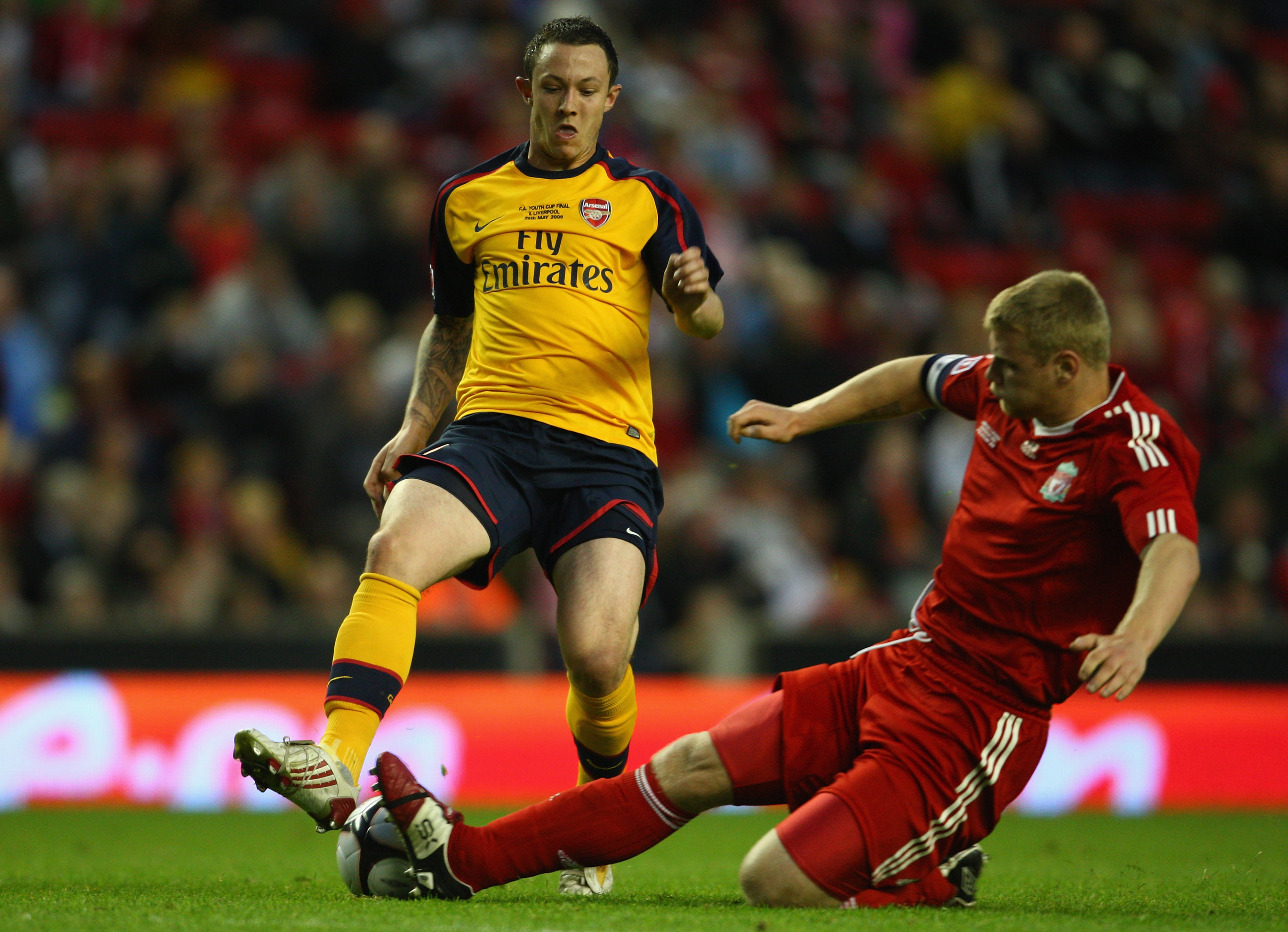 LIVERPOOL, ENGLAND - MAY 26:  Joe Kennedy of Liverpool tackles Rhys Murphy of Arsenal during the second leg of the FA Youth Cup final sponsored by E.ON, between Liverpool and Arsenal at Anfield on May 26, 2009 in Liverpool, England.  (Photo by Jamie McDon