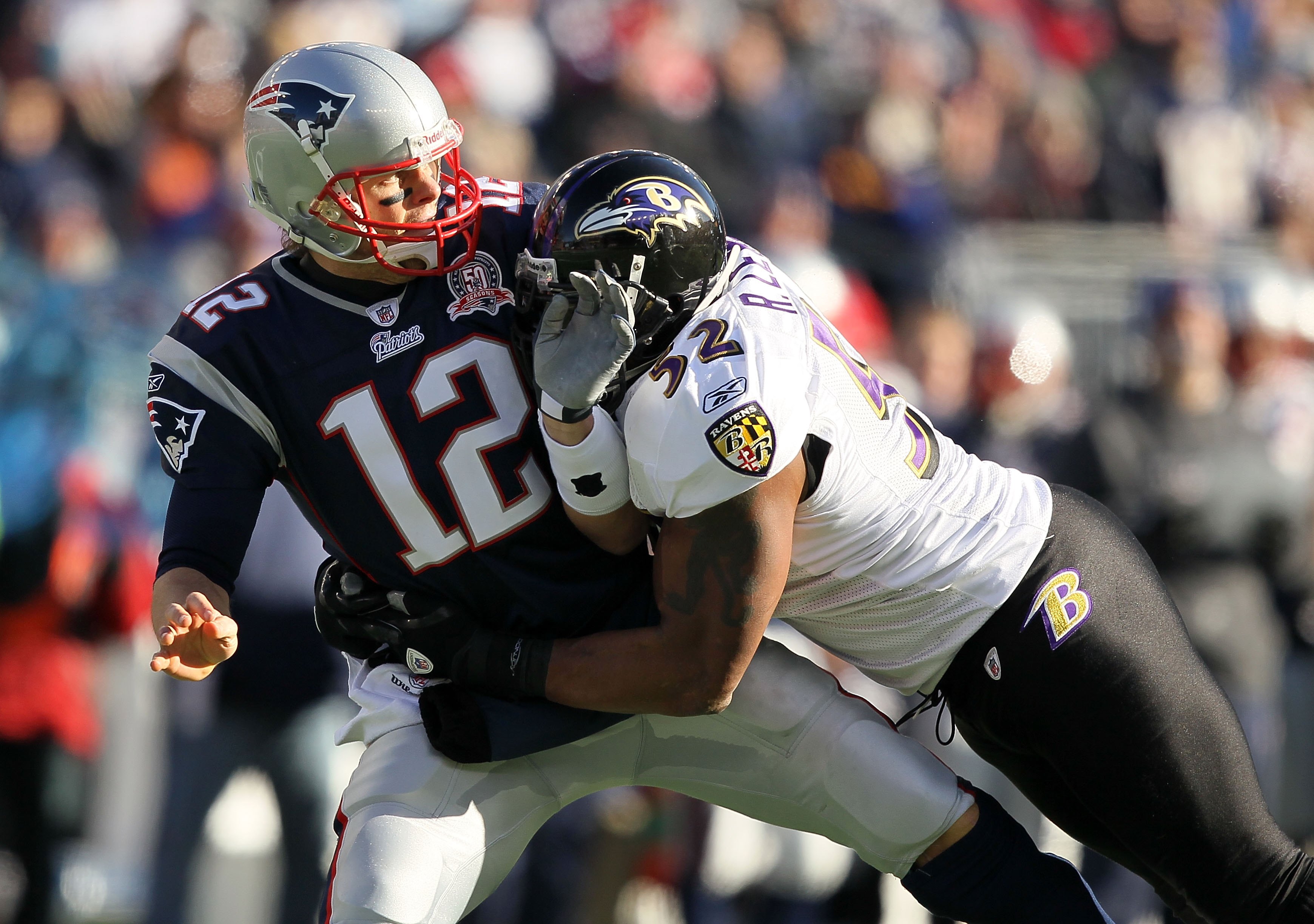 FOXBORO, MA - JANUARY 10:  Quarterback Tom Brady #12 of the New England Patriots is hit by Ray Lewis #52 of the Baltimore Ravens during the 2010 AFC wild-card playoff game at Gillette Stadium on January 10, 2010 in Foxboro, Massachusetts. The Ravens won 3