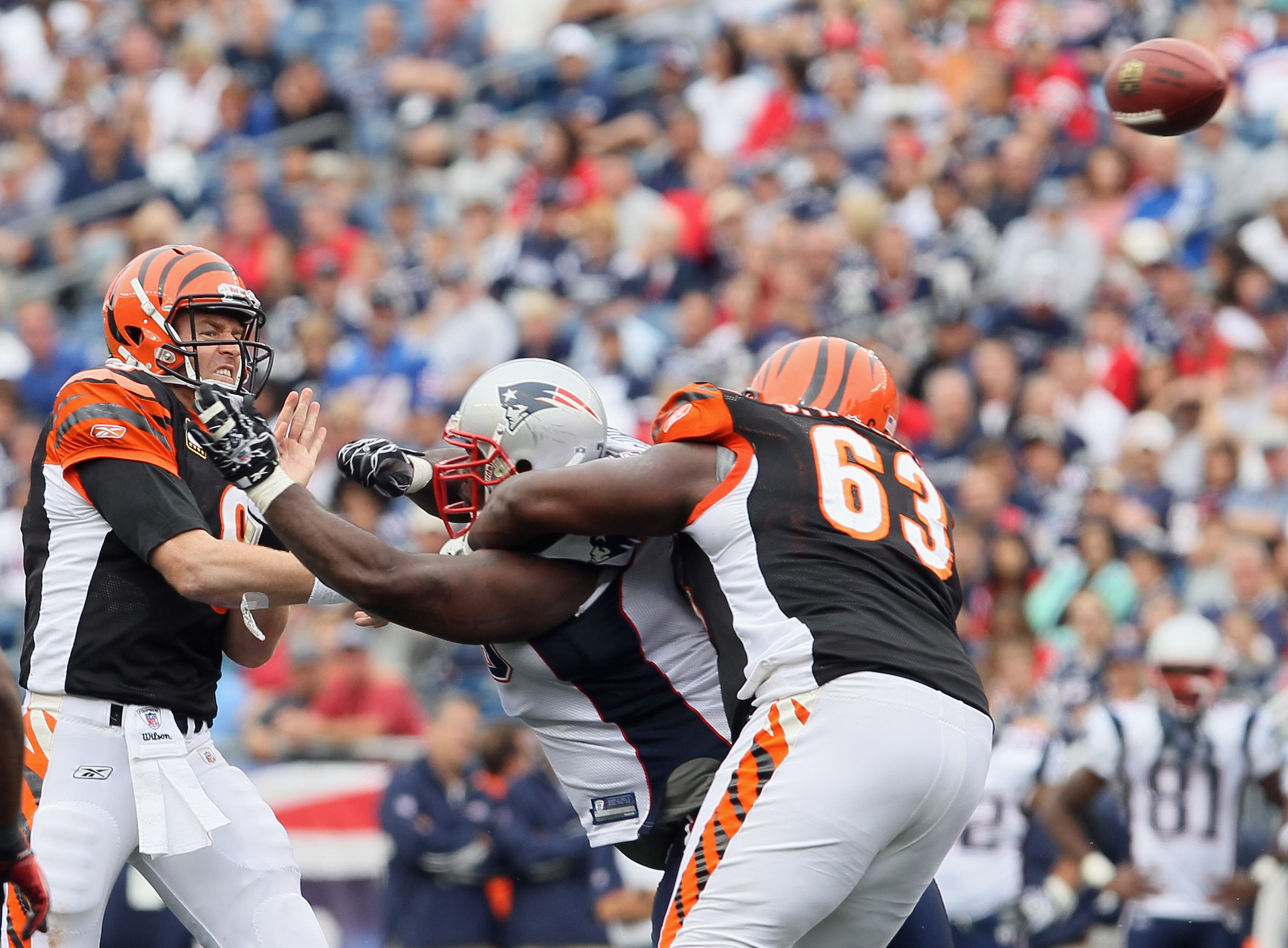 FOXBORO, MA - SEPTEMBER 12:  Carson Palmer #9 of the Cincinnati Bengals passes as teammate Bobbie Williams #63 holds off Vince Wilfork #75 of the New England Patriots during the NFL season opener on September 12, 2010 at Gillette Stadium in Foxboro, Massa