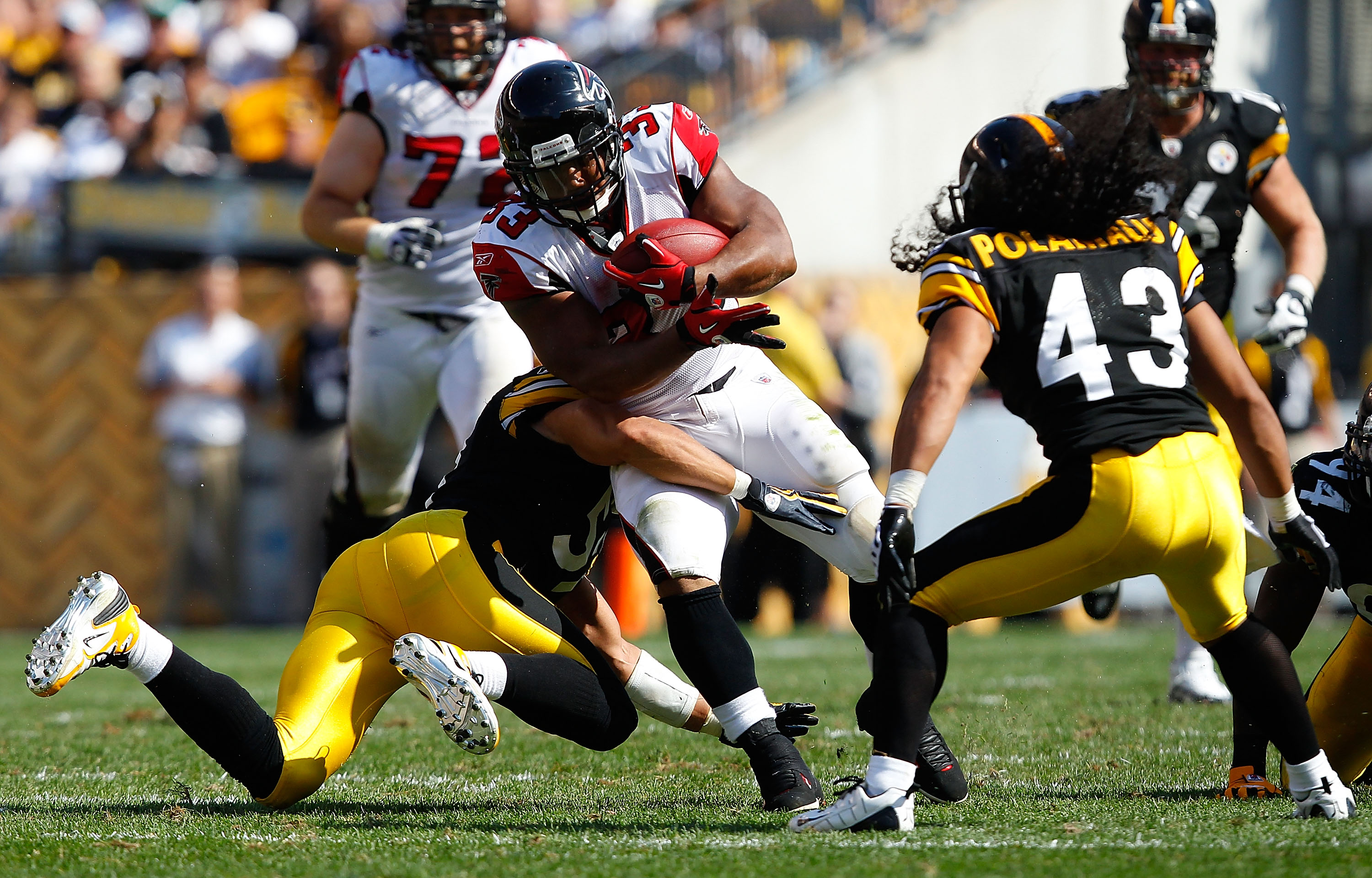 PITTSBURGH - SEPTEMBER 12:  Michael Turner #33 of the Atlanta Falcons attempts to run through a tackle by James Farrior #51 of the Pittsburgh Steelers during the NFL season opener game on September 12, 2010 at Heinz Field in Pittsburgh, Pennsylvania.  (Ph