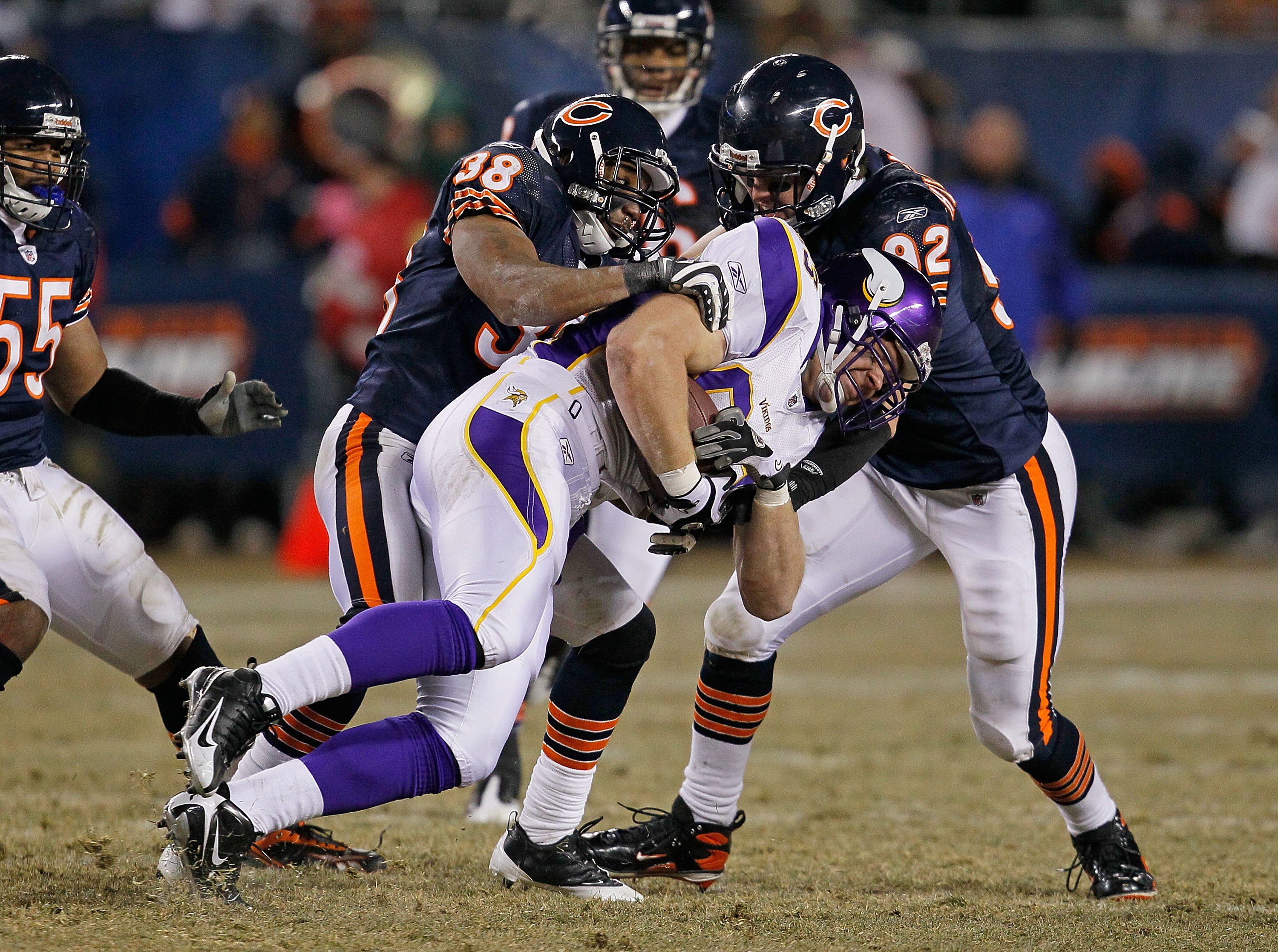 CHICAGO - DECEMBER 28: Jeff Dugan #83 of the Minnesota Vikings is brought down by Danieal Manning #38 and Hunter Hillenmeyer #92 of the Chicago Bears as teammate Lance Briggs #55 moves in at Soldier Field on December 28, 2009 in Chicago, Illinois. The Bea