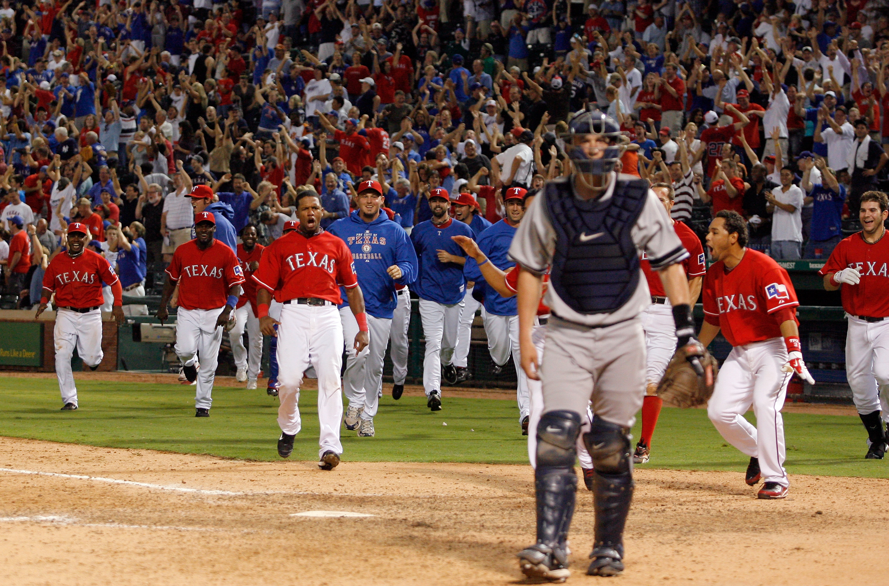 ARLINGTON, TX - SEPTEMBER 10:  The Texas Rangers celebrate at home plate after Nelson Cruz #17 hit the game-winning home run in the bottom of the 13th inning against the New York Yankees on September 10, 2010 at Rangers Ballpark in Arlington, Texas.  (Pho