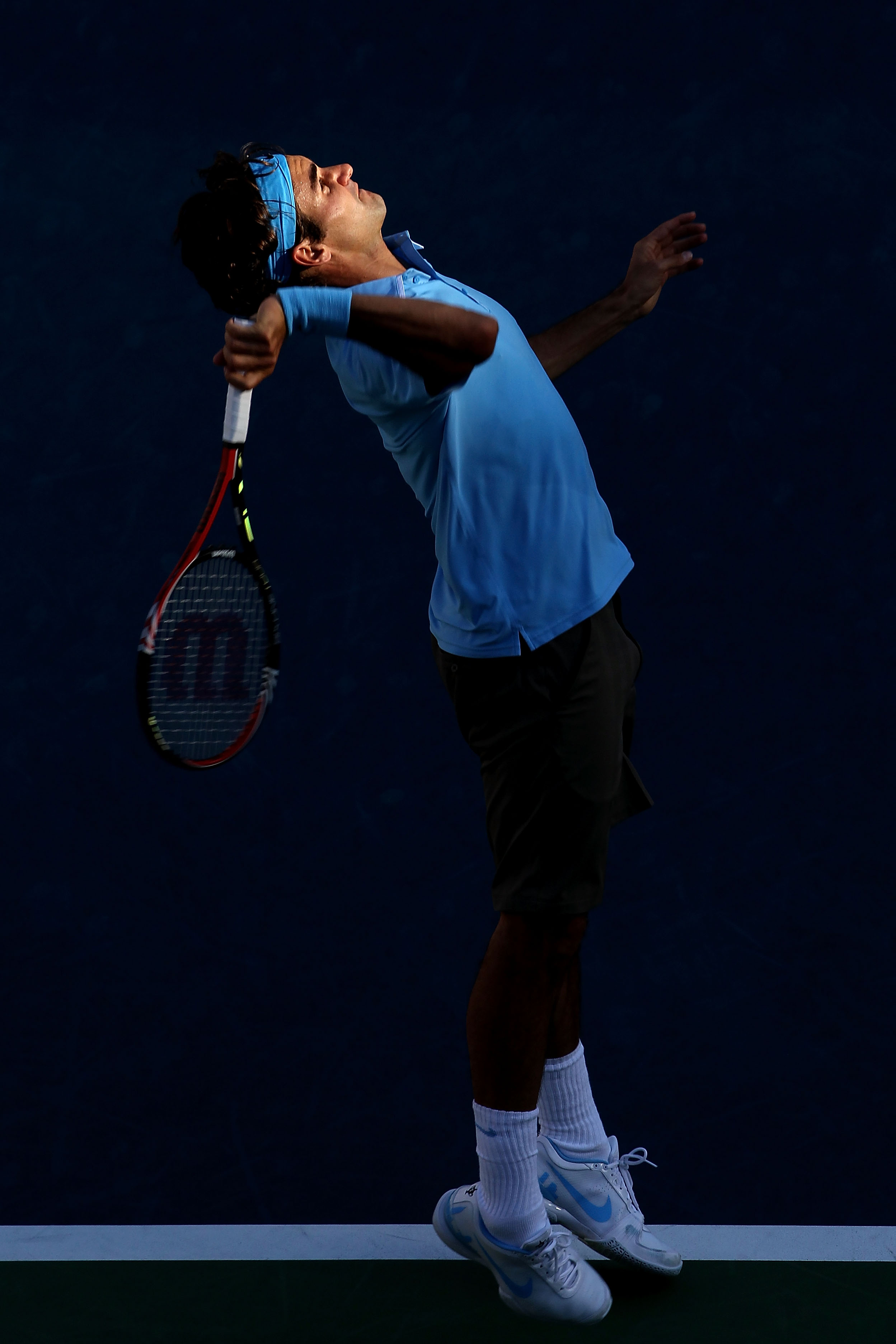 NEW YORK - SEPTEMBER 11:  Roger Federer of Switzerland serves against Novak Djokovic of Serbia during his men's singles semifinal match on day thirteen of the 2010 U.S. Open at the USTA Billie Jean King National Tennis Center on September 11, 2010 in the