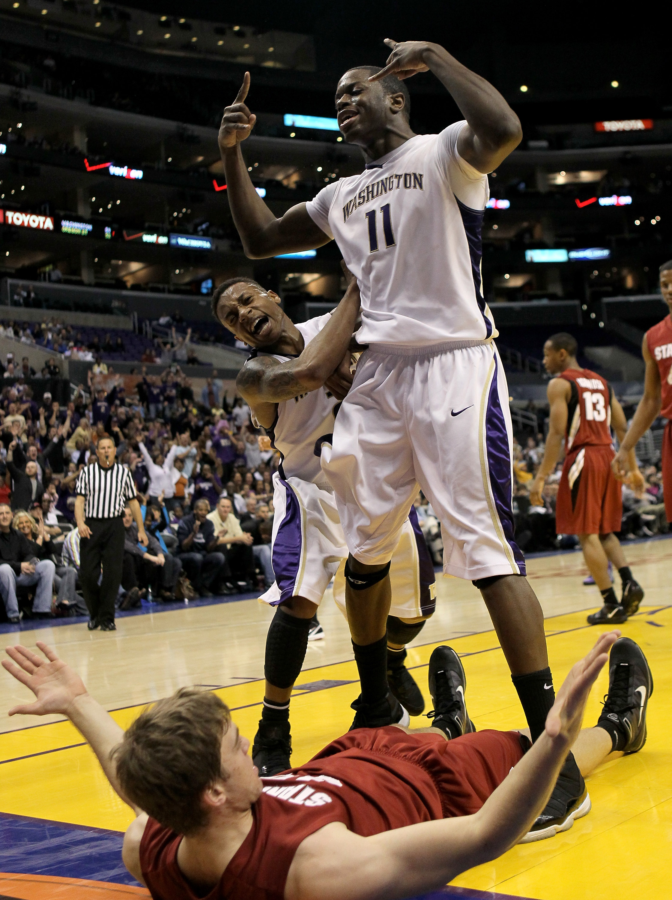 LOS ANGELES, CA - MARCH 12: Matthew Bryan-Amaning #11 and Isaiah Thomas #3 of the Washington Huskies celebrate Bryan-Amaning's dunk over Andrew Zimmermann #34 of the Stanford Cardinal during the semifinals of the Pac-10 Basketball Tournament at Staples C