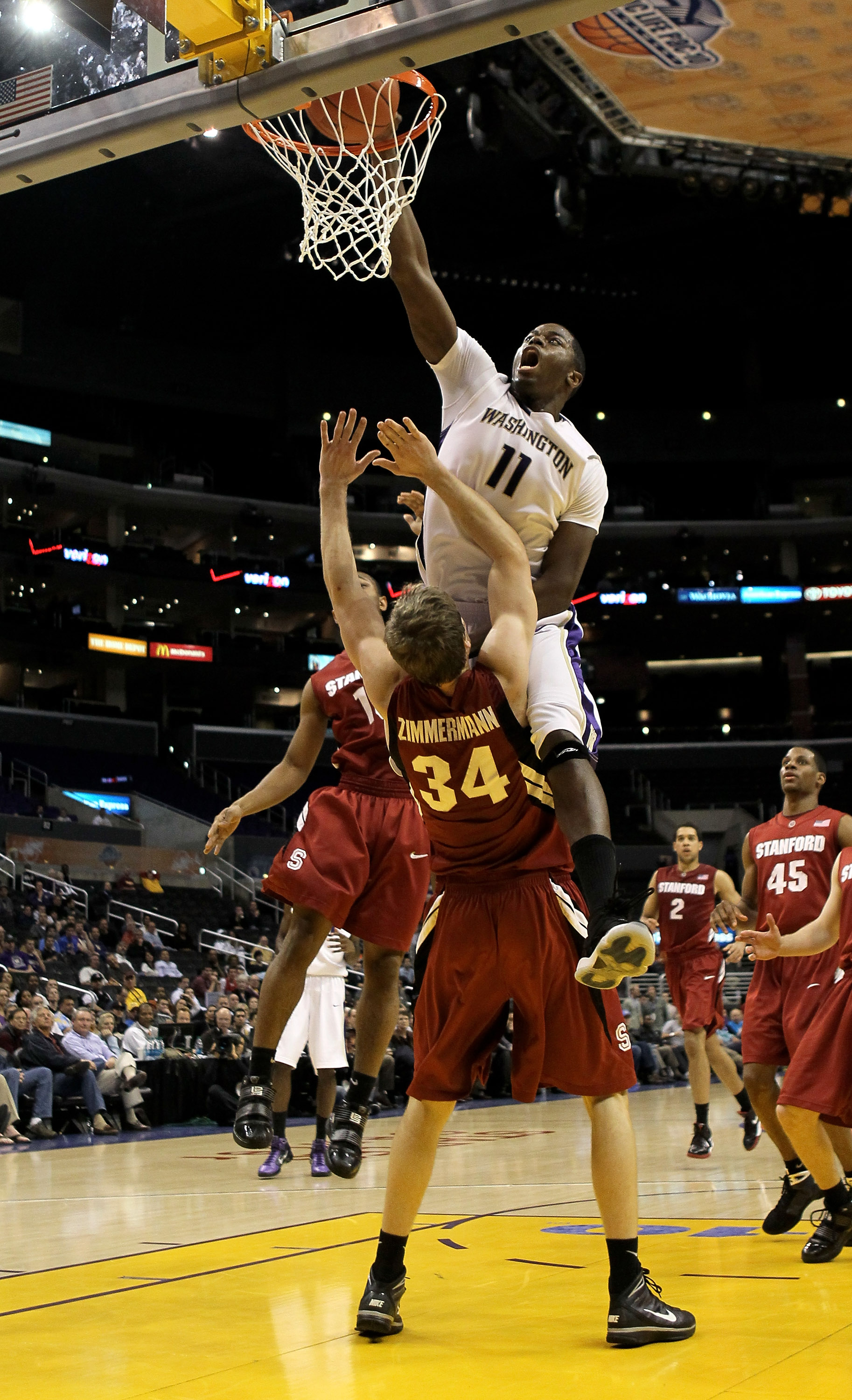 LOS ANGELES, CA - MARCH 12: Matthew Bryan-Amaning #11 of the Washington Huskies dunks over Andrew Zimmermann #34 of the Stanford Cardinal during the semifinals of the Pac-10 Basketball Tournament at Staples Center on March 12, 2010 in Los Angeles, Califo
