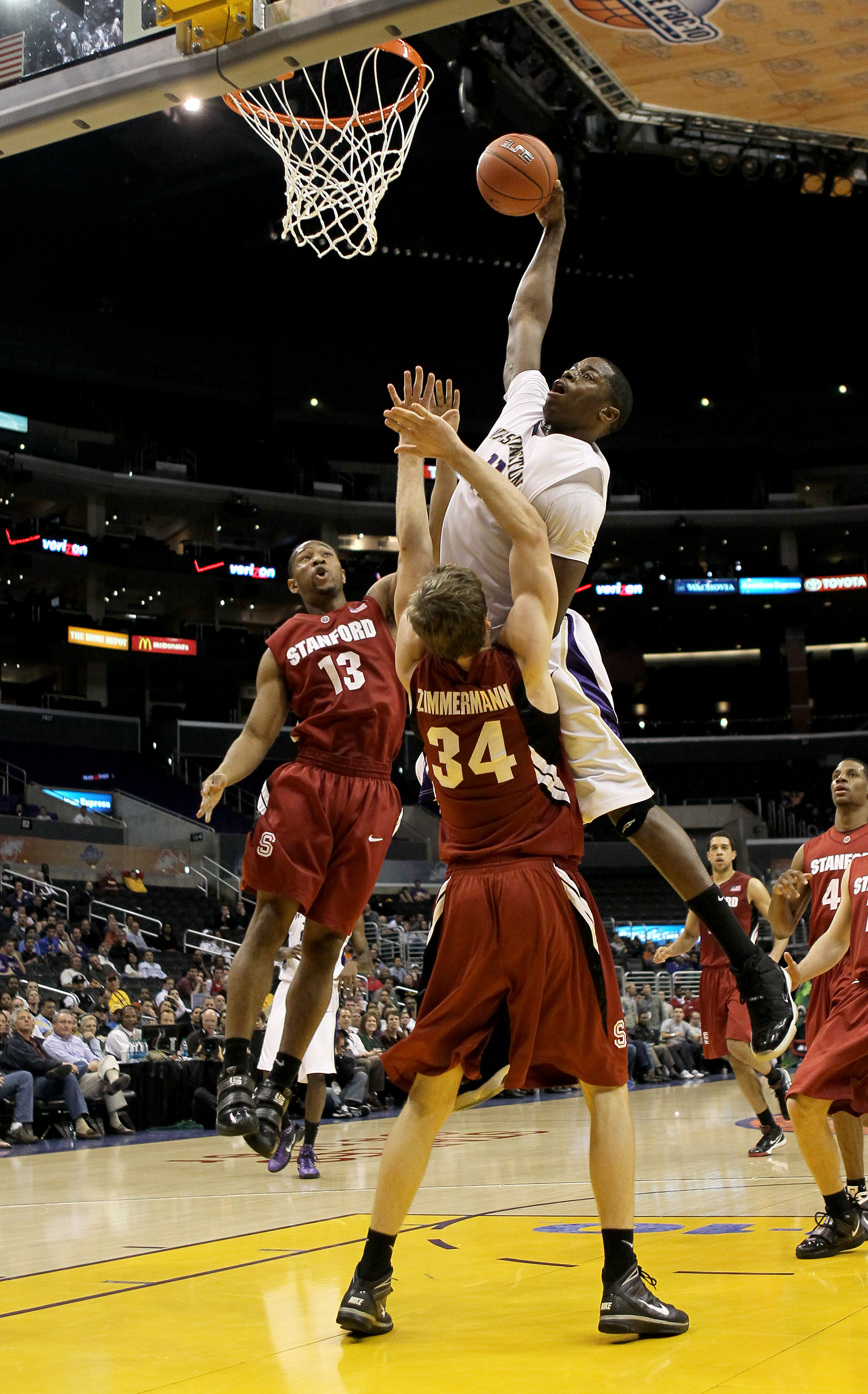 LOS ANGELES, CA - MARCH 12: Matthew Bryan-Amaning #11 of the Washington Huskies dunks over Andrew Zimmermann #34 of the Stanford Cardinal during the semifinals of the Pac-10 Basketball Tournament at Staples Center on March 12, 2010 in Los Angeles, Califor