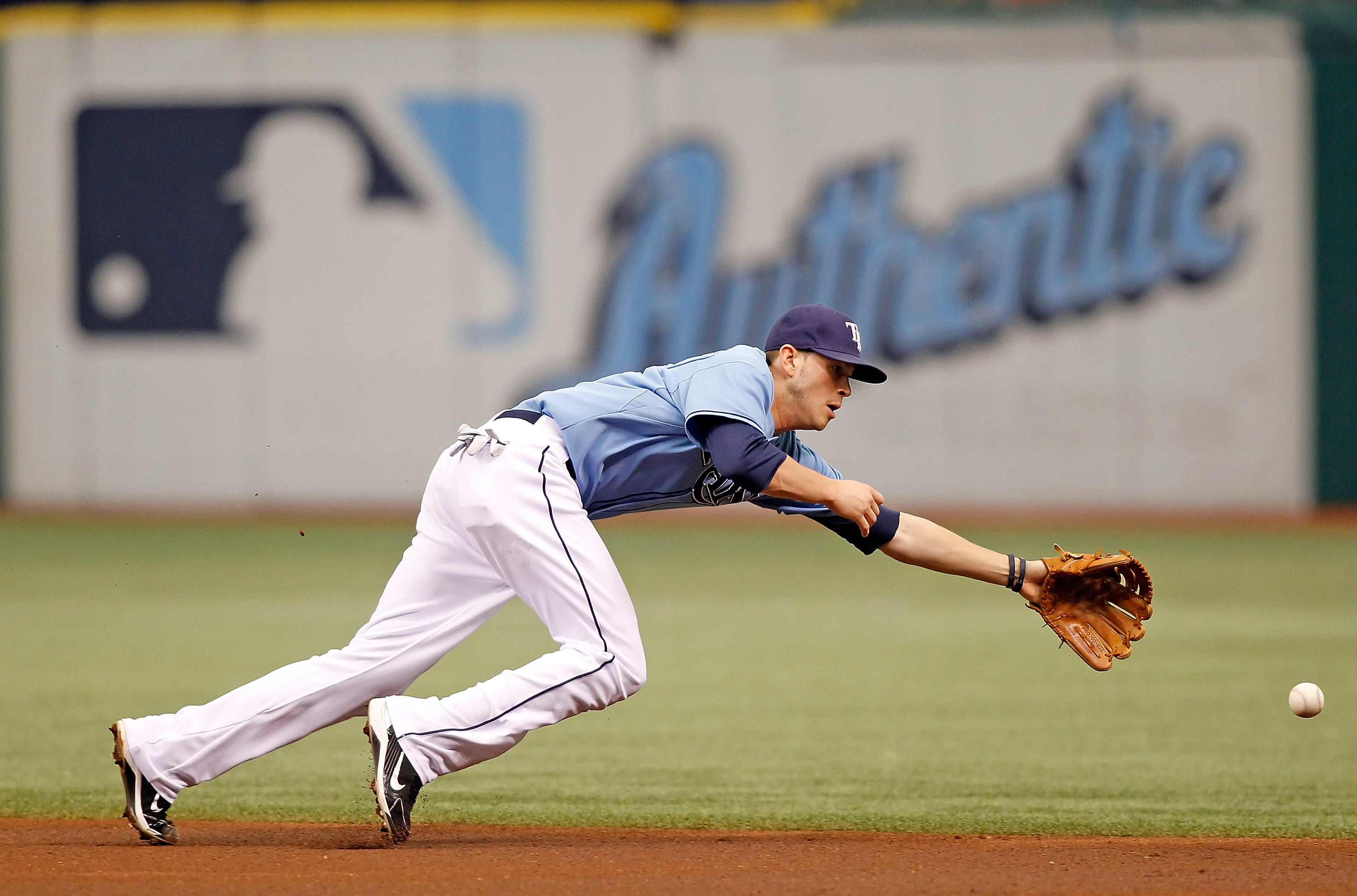 ST. PETERSBURG - AUGUST 01:  Infielder Reid Brignac #15 of the Tampa Bay Rays dives for a ball against the New York Yankees during the game at Tropicana Field on August 1, 2010 in St. Petersburg, Florida.  (Photo by J. Meric/Getty Images)