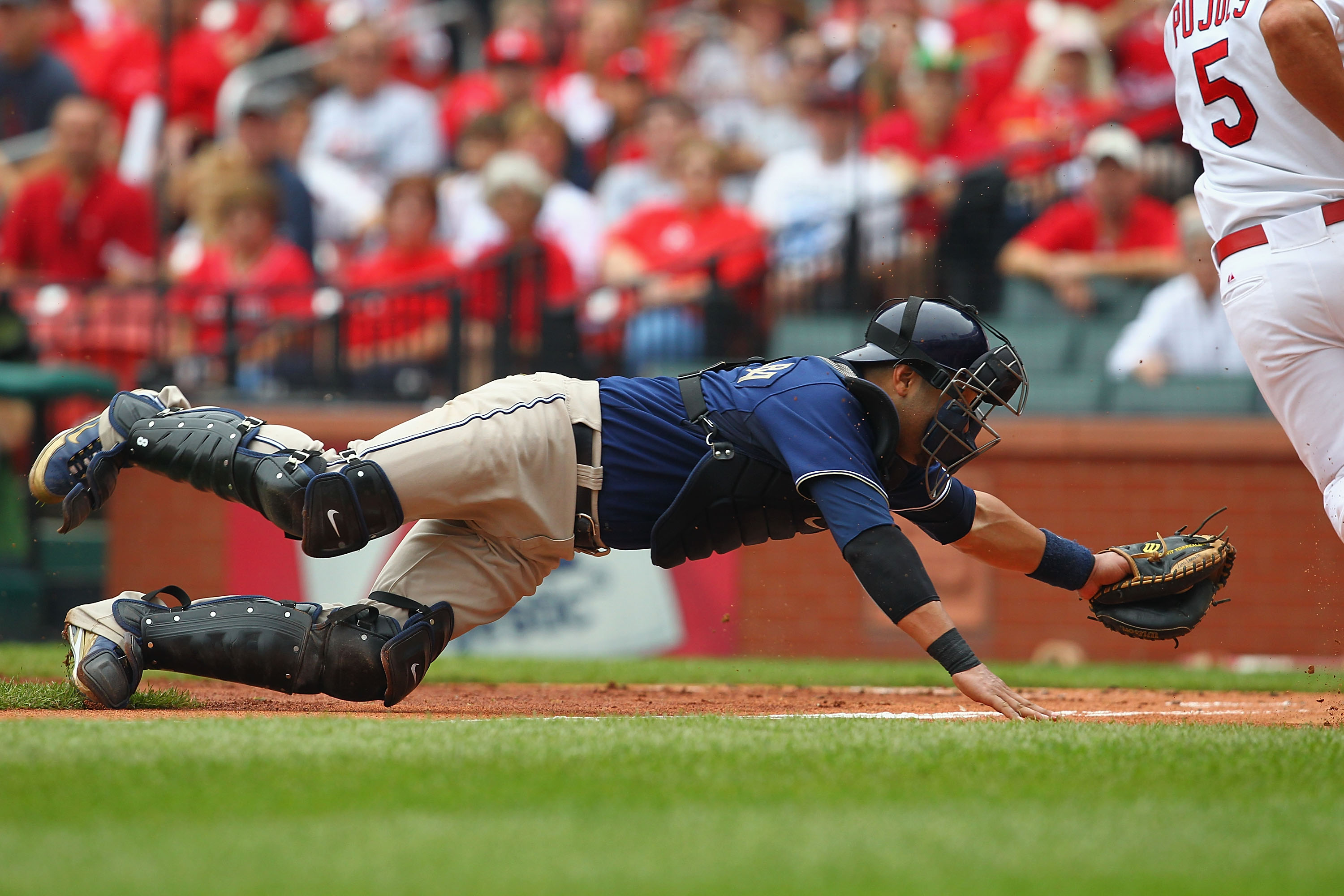 ST. LOUIS - SEPTEMBER 19: Yorvit Torrealba #8 of the San Diego Padres attempts to tag out Albert Pujols #5 of the St. Louis Cardinals at Busch Stadium on September 19, 2010 in St. Louis, Missouri.  The Cardinals beat the Padres 4-1.  (Photo by Dilip Vishw
