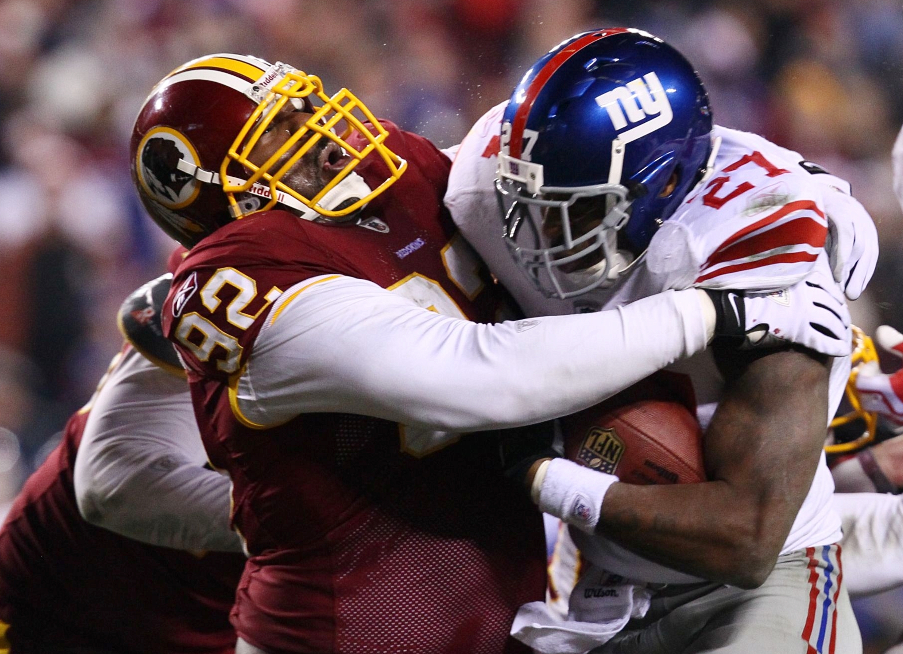 New York Giants running back Brandon Jacobs (27) is brought down