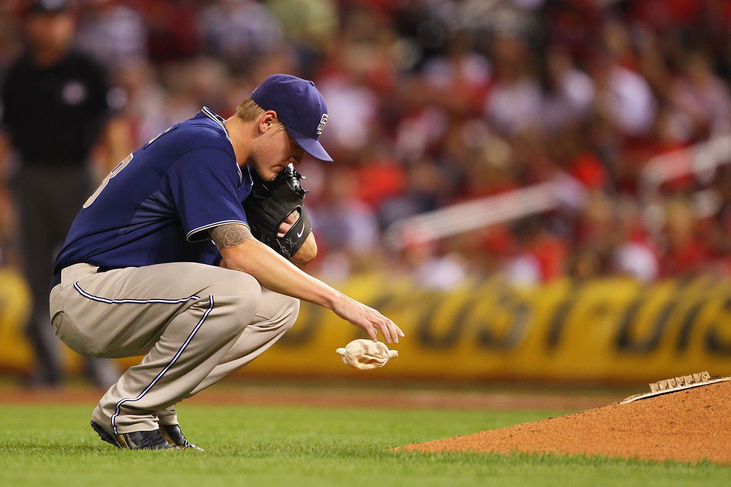 ST. LOUIS - SEPTEMBER 17: Starter Matt Latos #38 of the San Diego Padres regroups after giving up consecutive hits against the St. Louis Cardinals at Busch Stadium on September 17, 2010 in St. Louis, Missouri.  (Photo by Dilip Vishwanat/Getty Images)