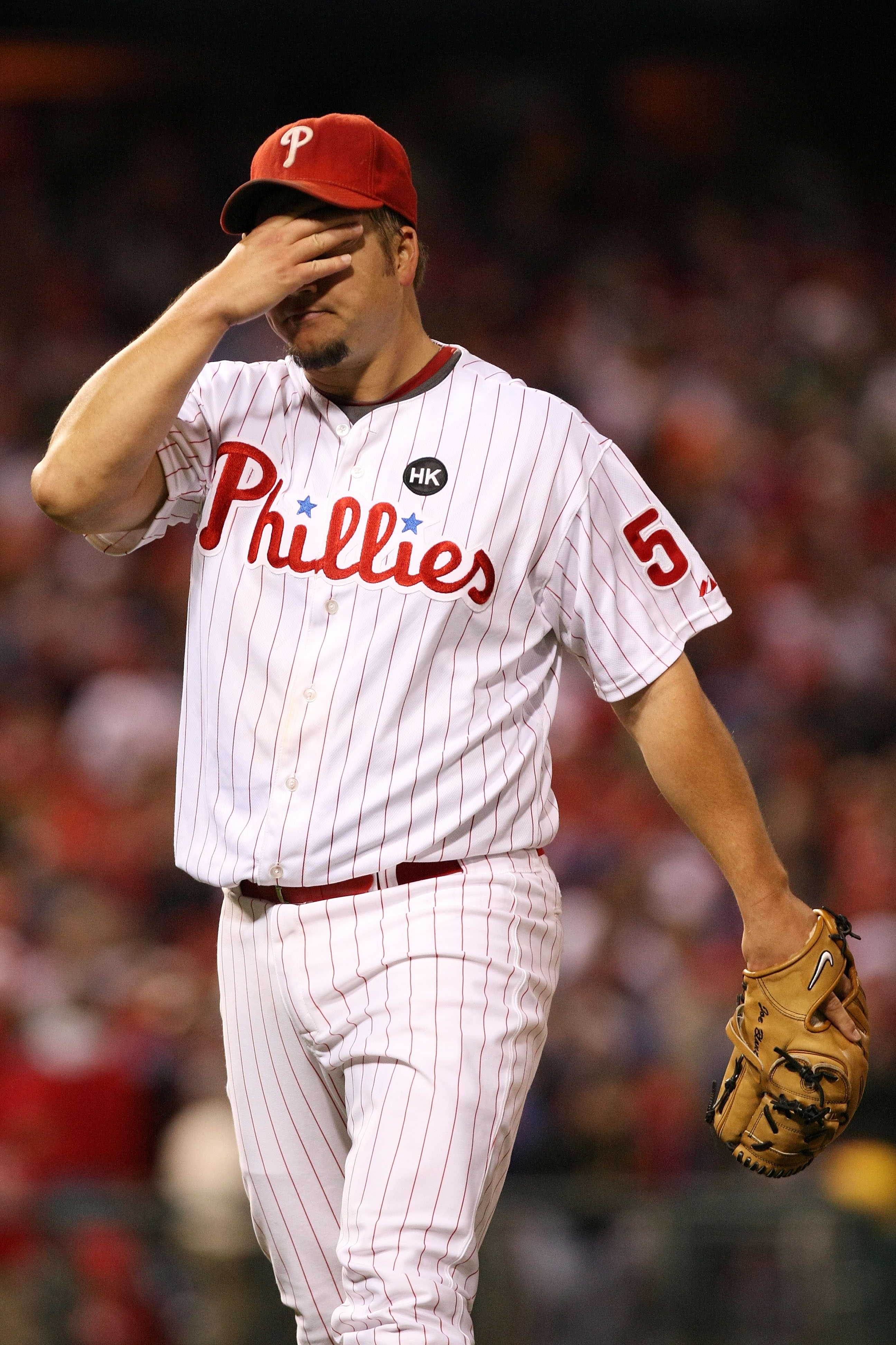 PHILADELPHIA - OCTOBER 19:  Starting pitcher Joe Blanton #56 of the Philadelphia Phillies wipes his forehead as he walks back to the dugout at the end of the top of the fourth inning against the Los Angeles Dodgers in Game Four of the NLCS during the 2009