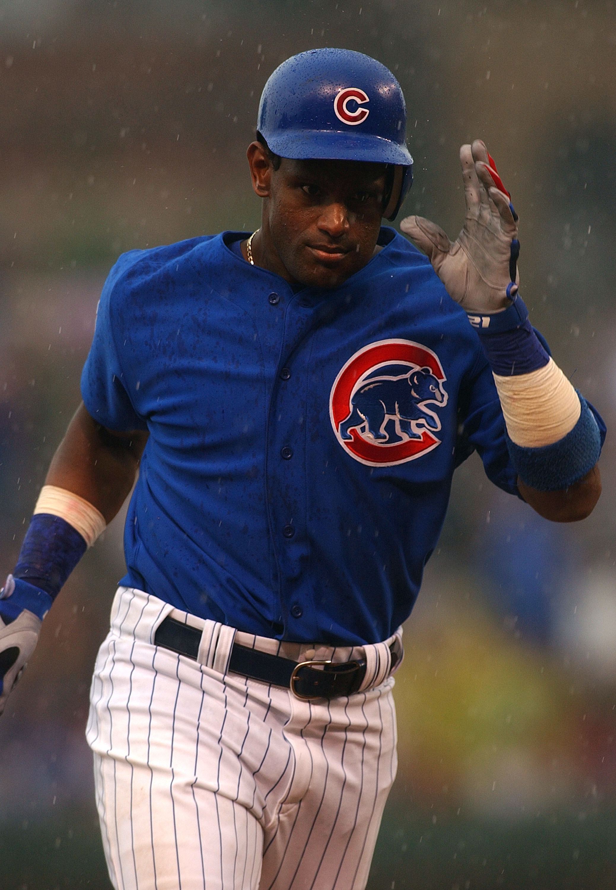 Chicago Cubs slugger Sammy Sosa hits a solo home run in the eighth