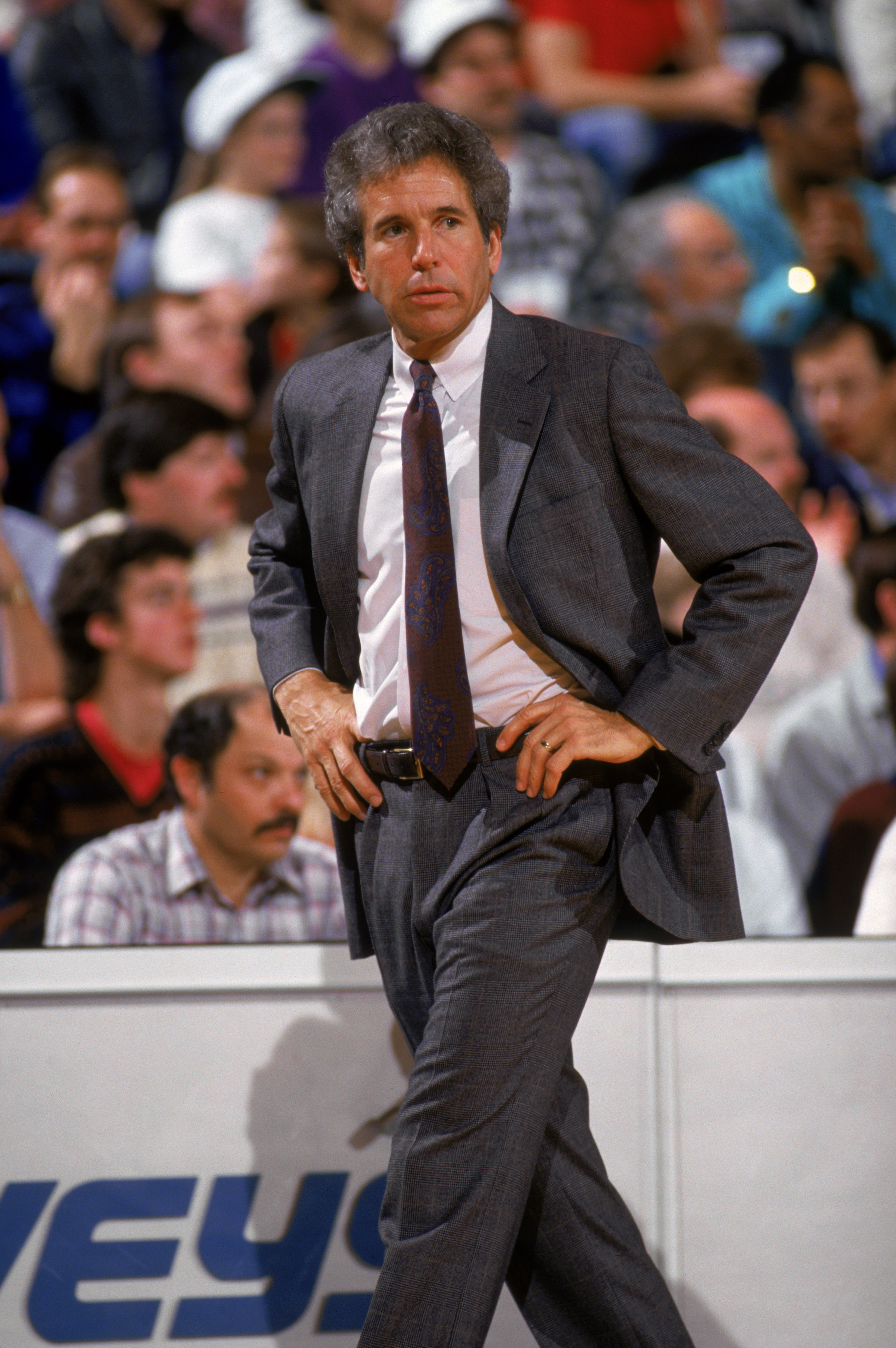 OAKLAND, CALIFORNIA - 1987:  Head Coach John MacLeod of the Dallas Mavericks paces the sideline during an NBA game against the Golden State Warriors at the Arena in Oakland, California in 1987. NOTE TO USER: User expressly acknowledges and agrees that, by