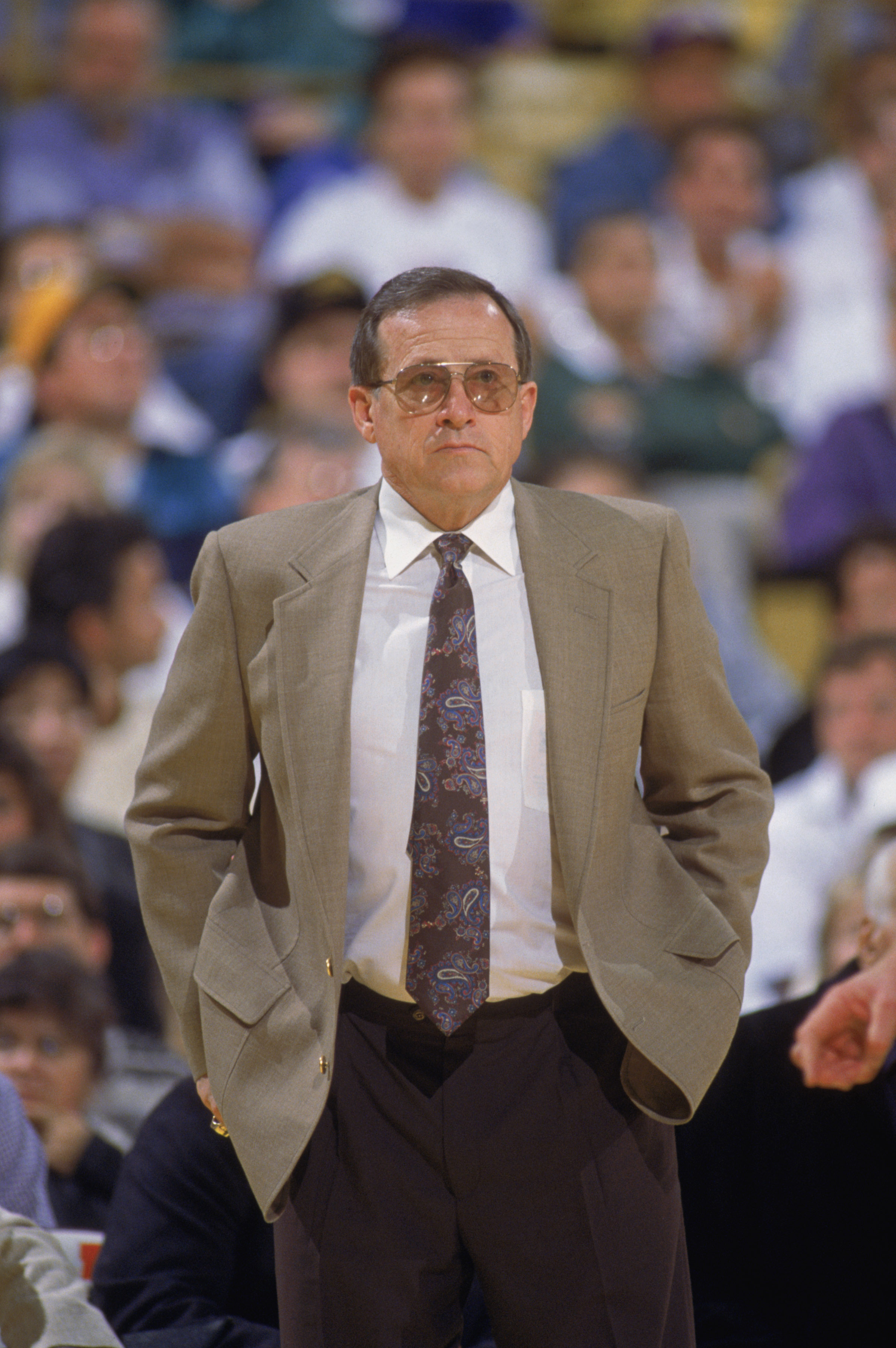 LOS ANGELES - 1990:  Head coach Dick Motta of the Sacramento Kings stands on the sideline during an NBA game against the Los Angeles Lakers at the Great Western Forum in Los Angeles, California in 1990. (Photo by Ken Levine/Getty Images)