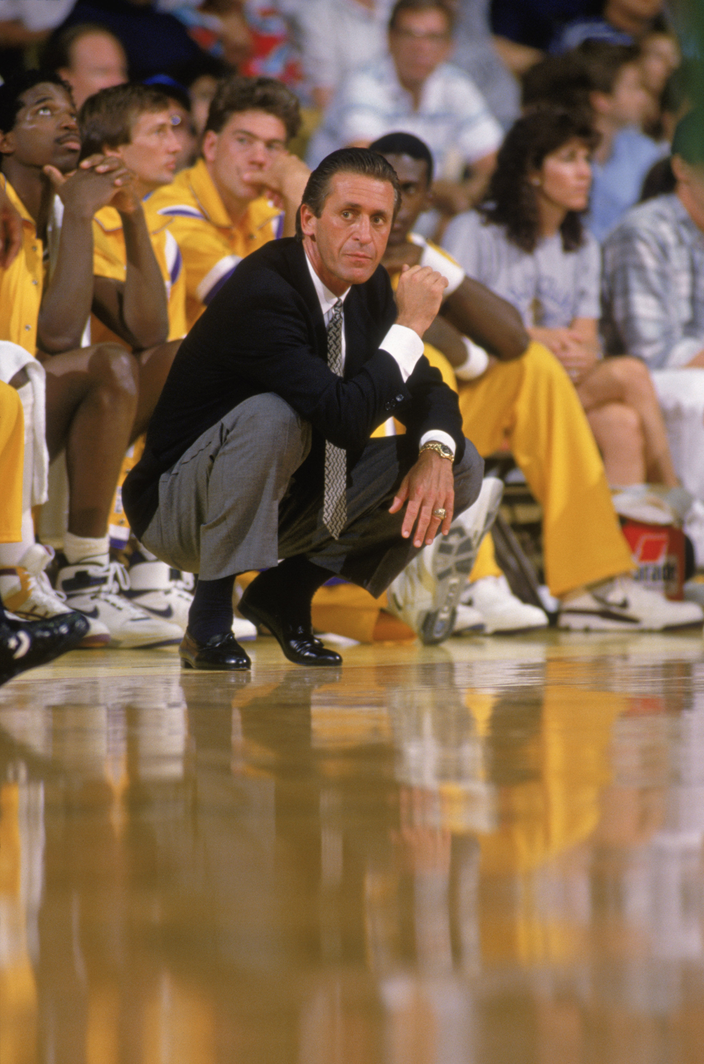 LOS ANGELES - 1988:  Head coach Pat Riley of the Los Angeles Lakers crouches on the sideline during an NBA game at the Great Western Forum in Los Angeles, California in 1988.  (Photo by: Tim Defrisco/Getty Images)