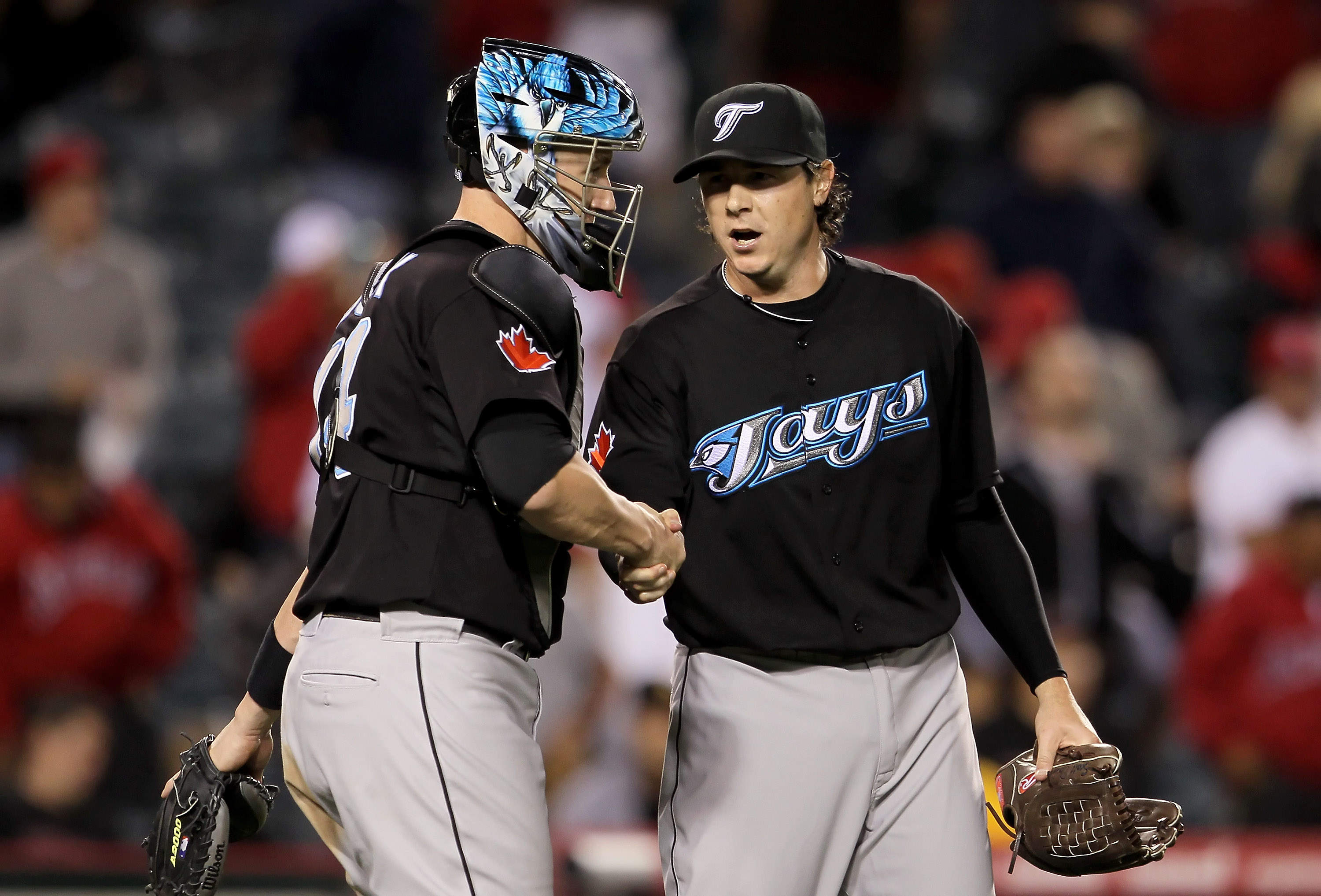 ANAHEIM, CA - MAY 24:  Catcher John Buck #14 and relief pitcher Scott Downs #37 of the Toronto Blue Jays congratulate each other following their victory over the Los Angeles Angels of Anaheim at Anaheim Stadium on May 24, 2010 in Anaheim, California. The 
