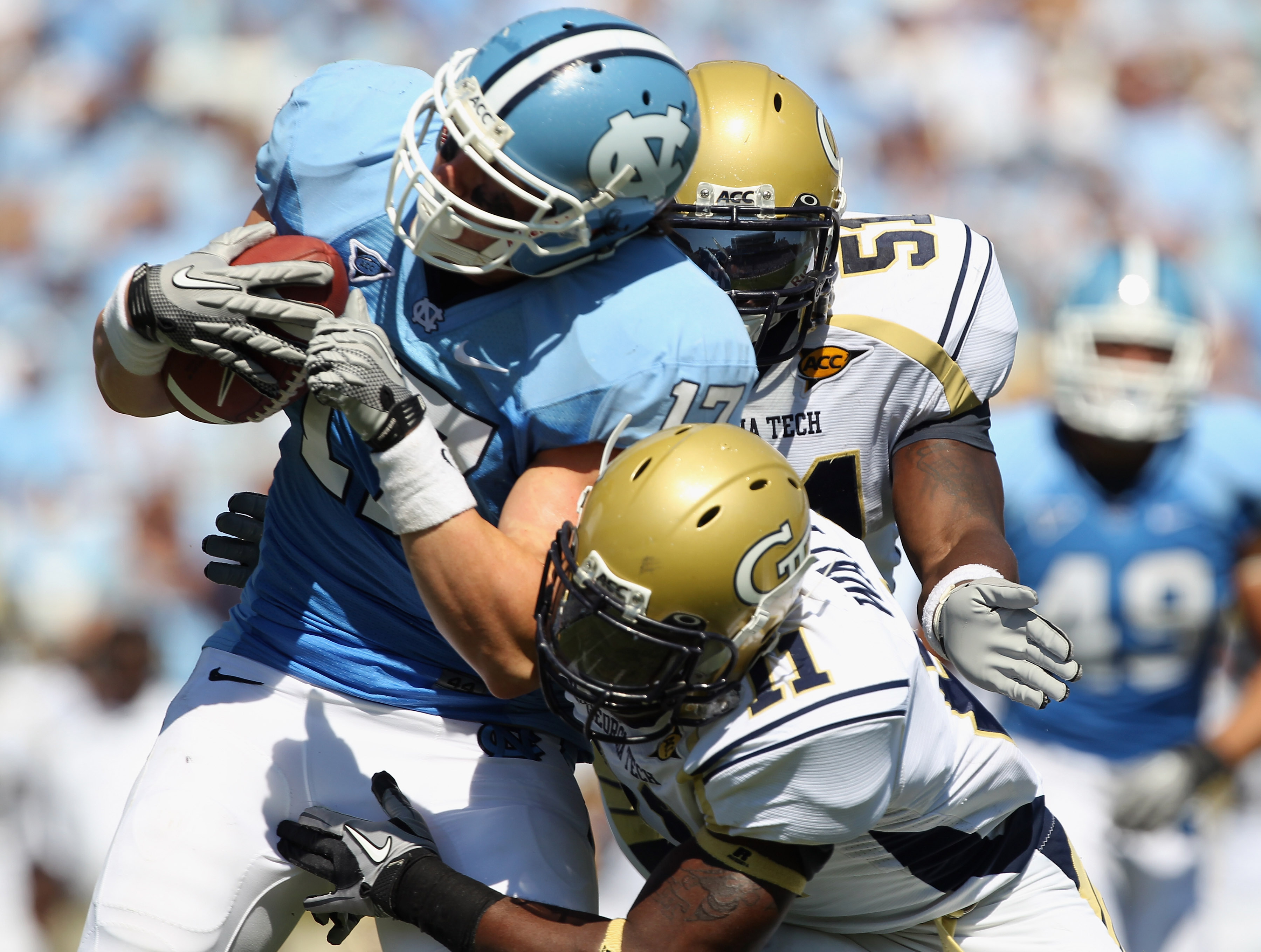CHAPEL HILL, NC - SEPTEMBER 18: Teammates Brandon Watts #11 and Brad Jefferson of the Georgia Tech Yellow Jackets tackle Zack Pianalto #17 of the North Carolina Tar Heels during their game at Kenan Stadium on September 18, 2010 in Chapel Hill, North Caro