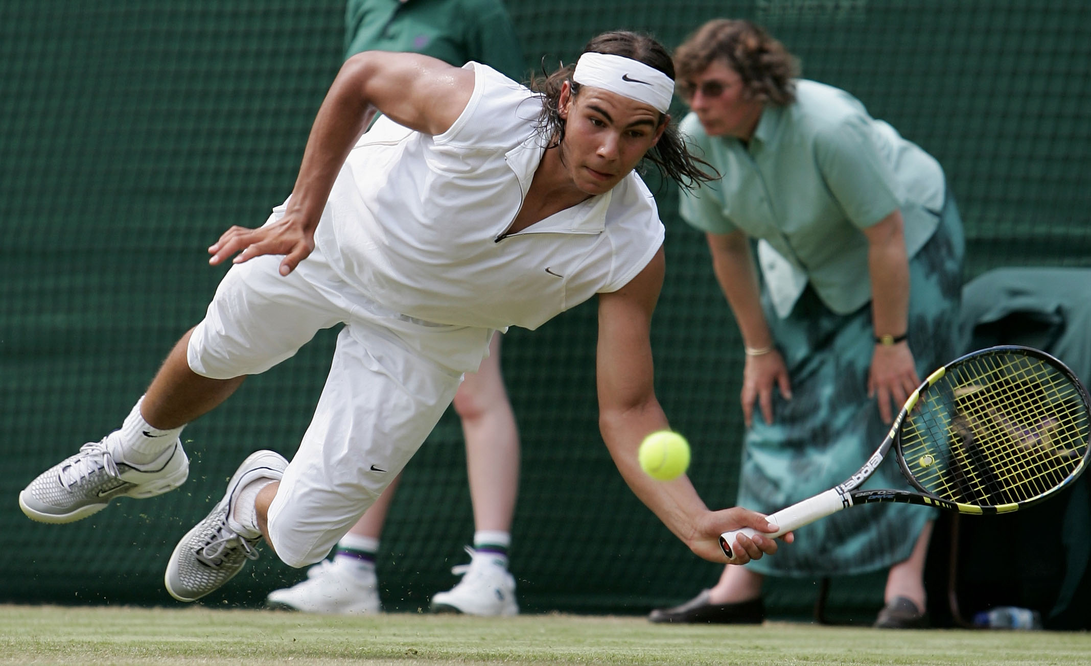 LONDON - JUNE 23:  Rafael Nadal of Spain dives for the ball against Gilles Muller of Luxembourg during the fourth day of the Wimbledon Lawn Tennis Championship on June 23, 2005 at the All England Lawn Tennis and Croquet Club in London.  (Photo by Phil Col
