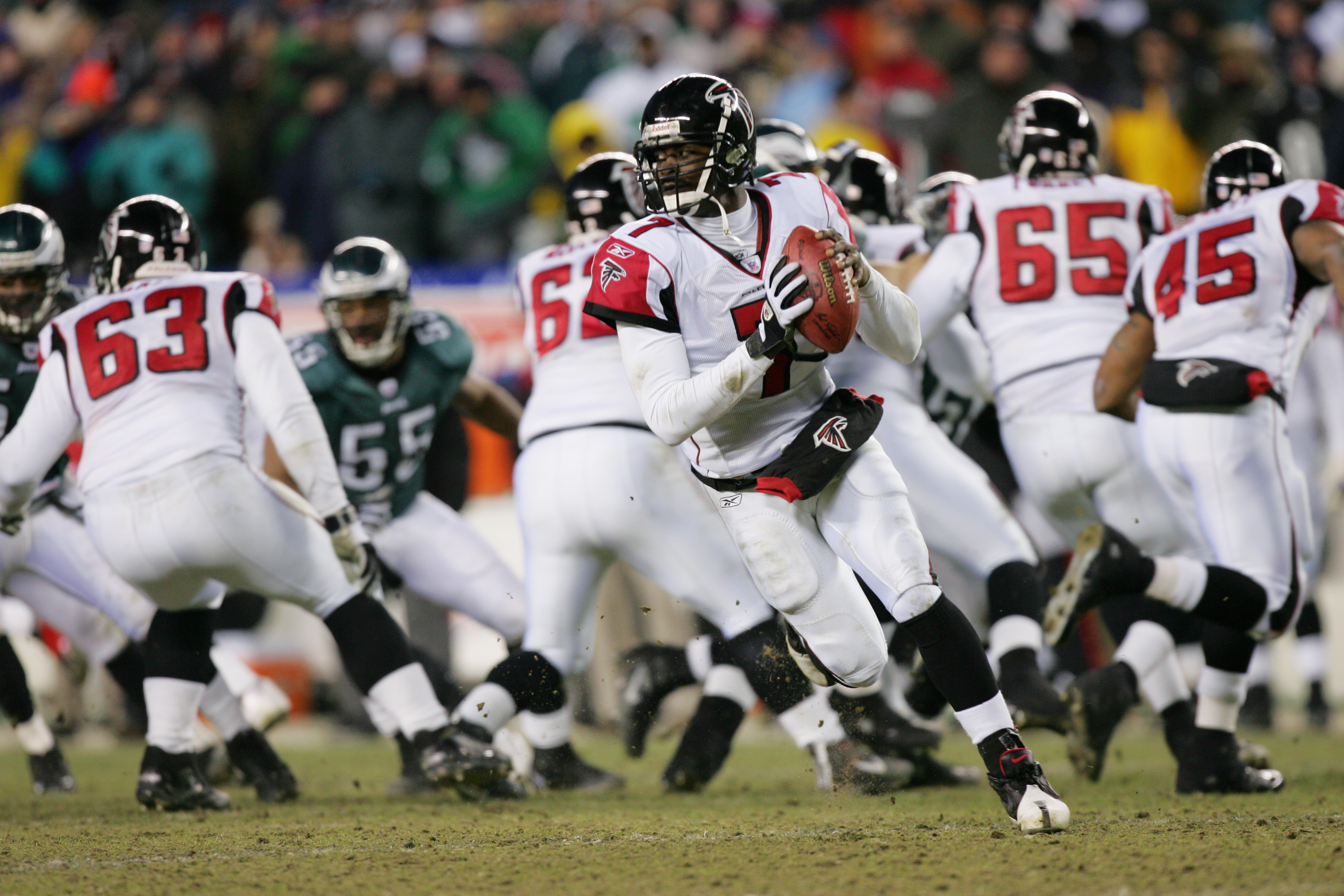 Quarterback Michael Vick of the Atlanta Falcons rolls out against