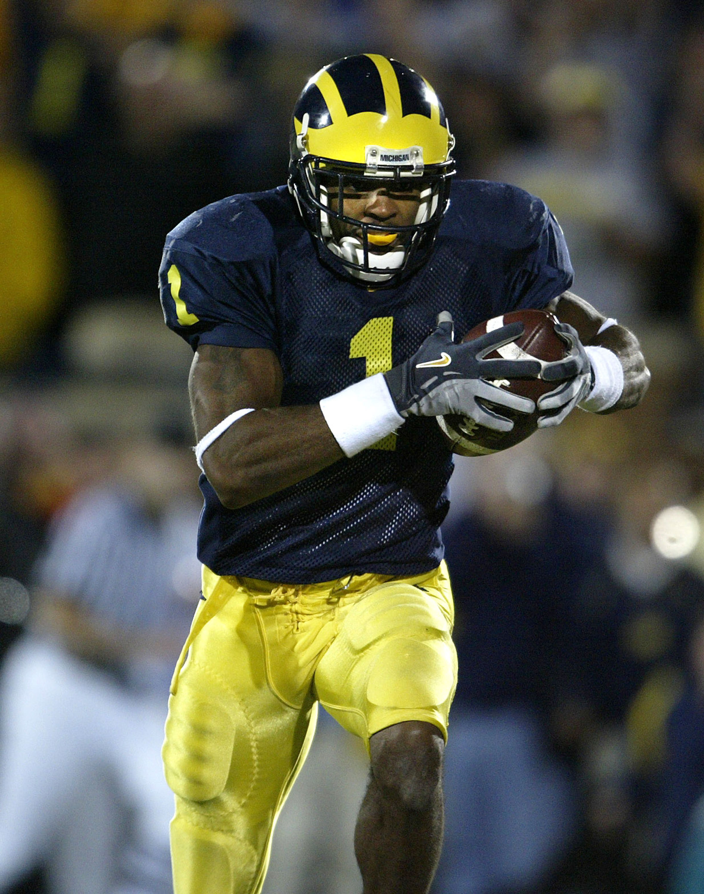 ANN ARBOR, MI - OCTOBER 30:  Wide Receiver Braylon Edwards #1 of the Michigan Wolverines catches a touchdown pass in the third overtime period against the Michigan State Spartans at Michigan Stadium on October 30, 2004 in Ann Arbor, Michigan. Michigan won