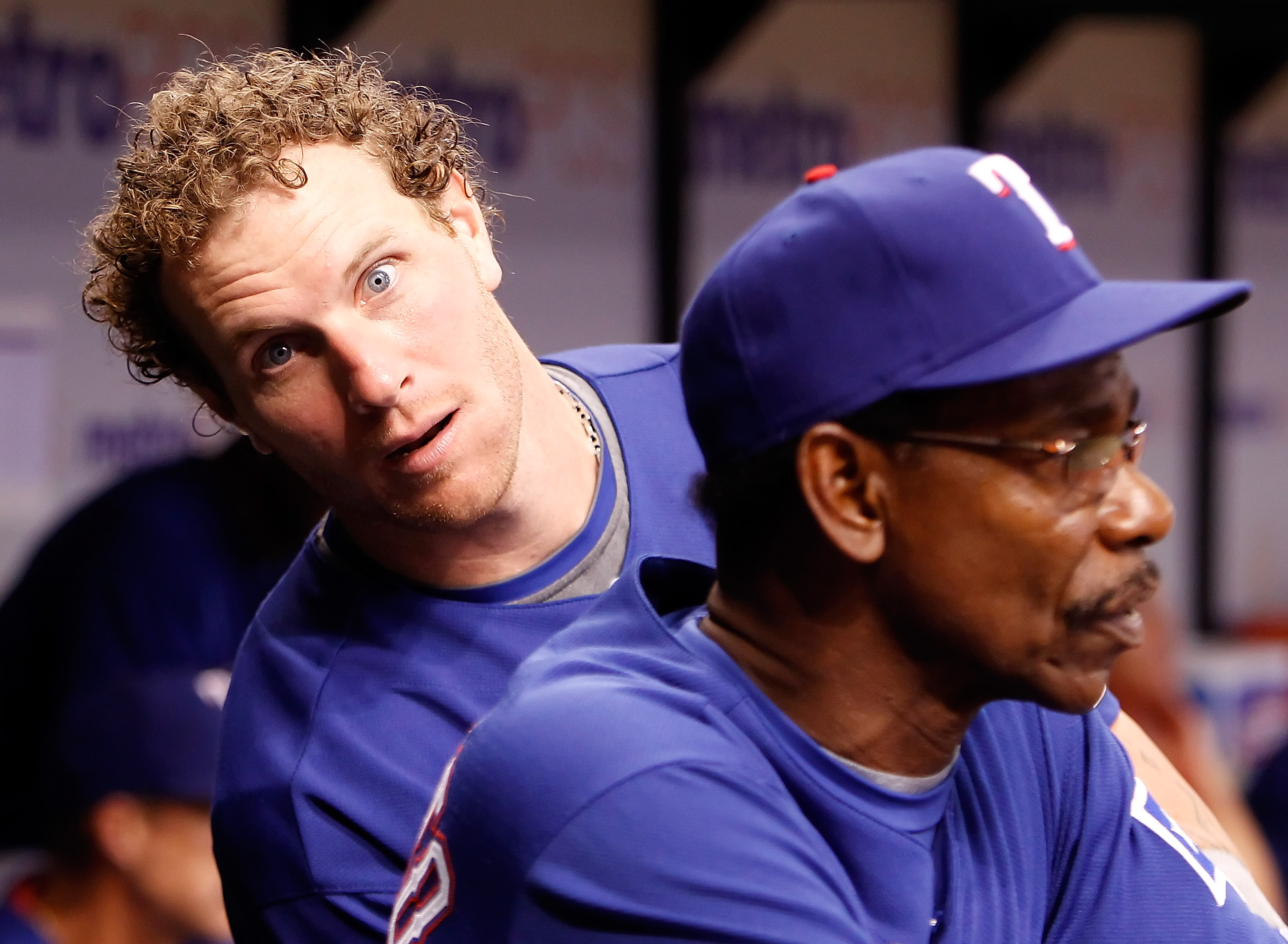 ST. PETERSBURG - AUGUST 17:  Outfielder Josh Hamilton #32 of the Texas Rangers clowns around behing manager Ron Washington #38 during the game against the Tampa Bay Rays at Tropicana Field on August 17, 2010 in St. Petersburg, Florida.  (Photo by J. Meric