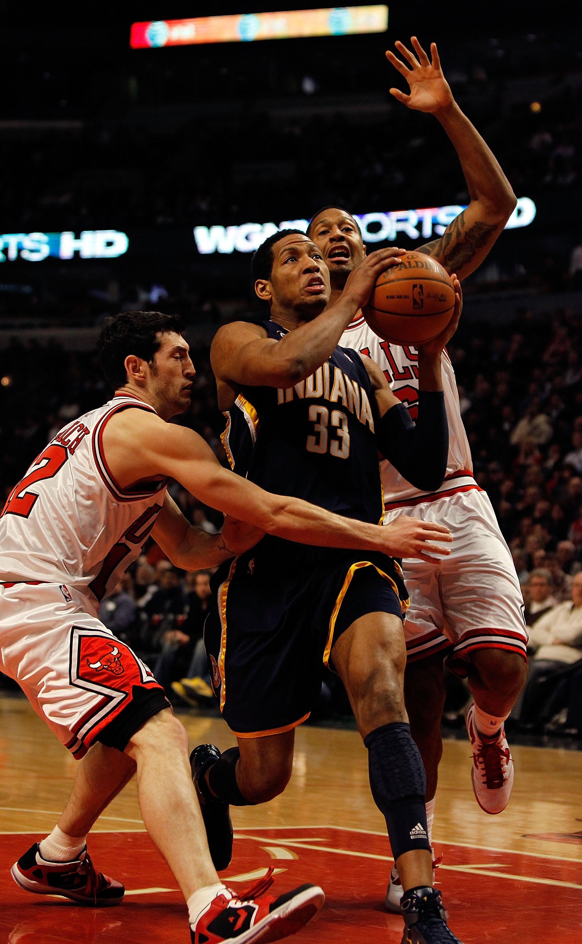 CHICAGO - FEBRUARY 24: Danny Granger #33 of the Indiana Pacers drives to the basket between Kirk Hinrich #12 and James Johnson #16 of the Chicago Bulls at the United Center on February 24, 2010 in Chicago, Illinois. The Bulls defeated the Pacers 120-110.