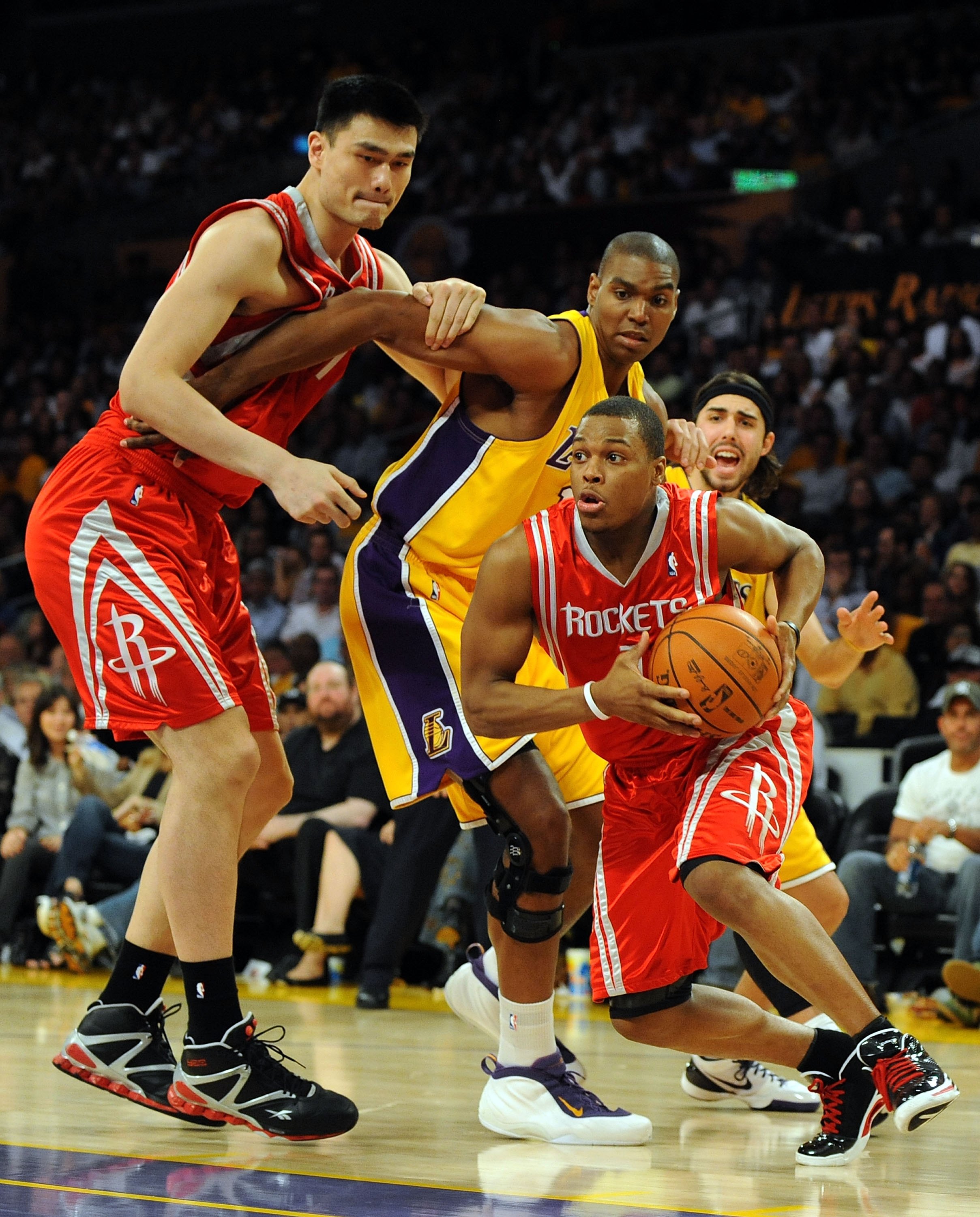 LOS ANGELES, CA - MAY 06:  Kyle Lowry #7 of the Houston Rockets drives by Sasha Vujacic #18 and Andrew Bynum #17 of the Los Angeles Lakers using a screen by Yao Ming #11 of the Rockets in Game Two of the Western Conference Semifinals during the 2009 NBA P