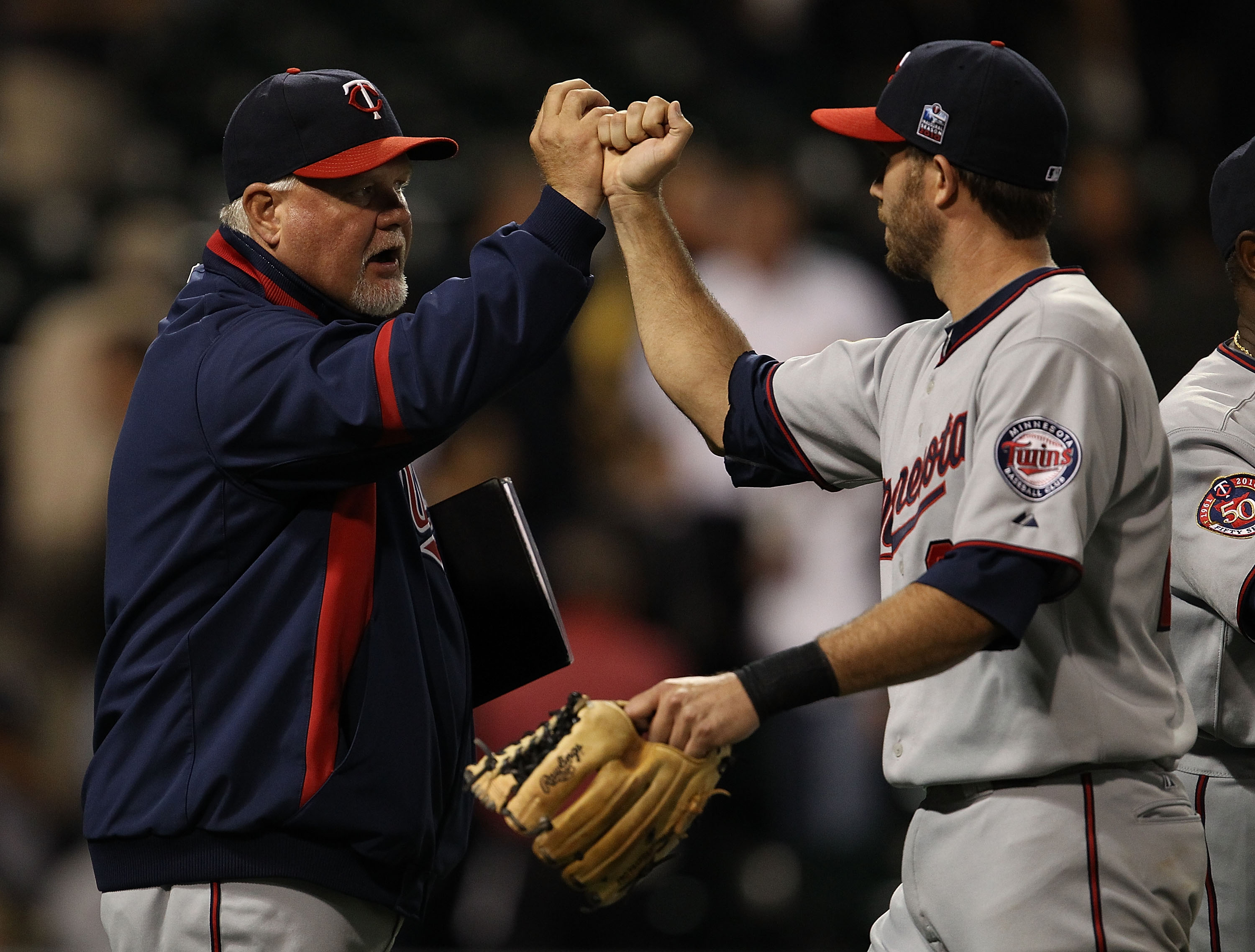 CHICAGO - SEPTEMBER 14: Manager Ron Gardenhire #35 of the Minnesota Twins congratulates J.J. Hardy #27 after a win over the Chicago White Sox at U.S. Cellular Field on September 14, 2010 in Chicago, Illinois. The Twins defeated the White Sox 9-3.  (Photo