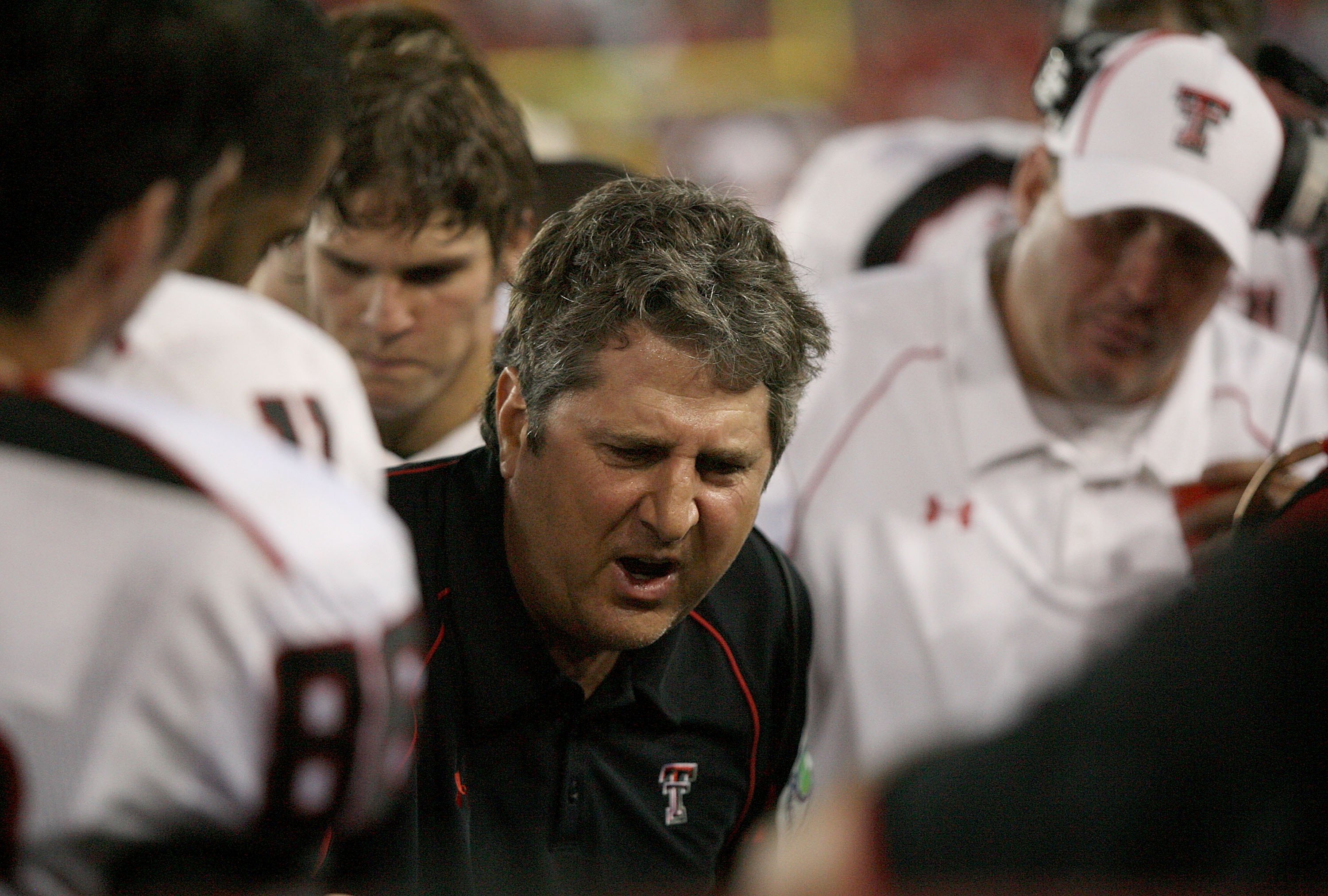 HOUSTON - SEPTEMBER 26: Head coach Mike Leach of the Texas Tech Red Raiders talks with his defense while playing against the University of Houston at Robertson Stadium on September 26, 2009 in Houston, Texas. (Photo by Thomas B. Shea/Getty Images)