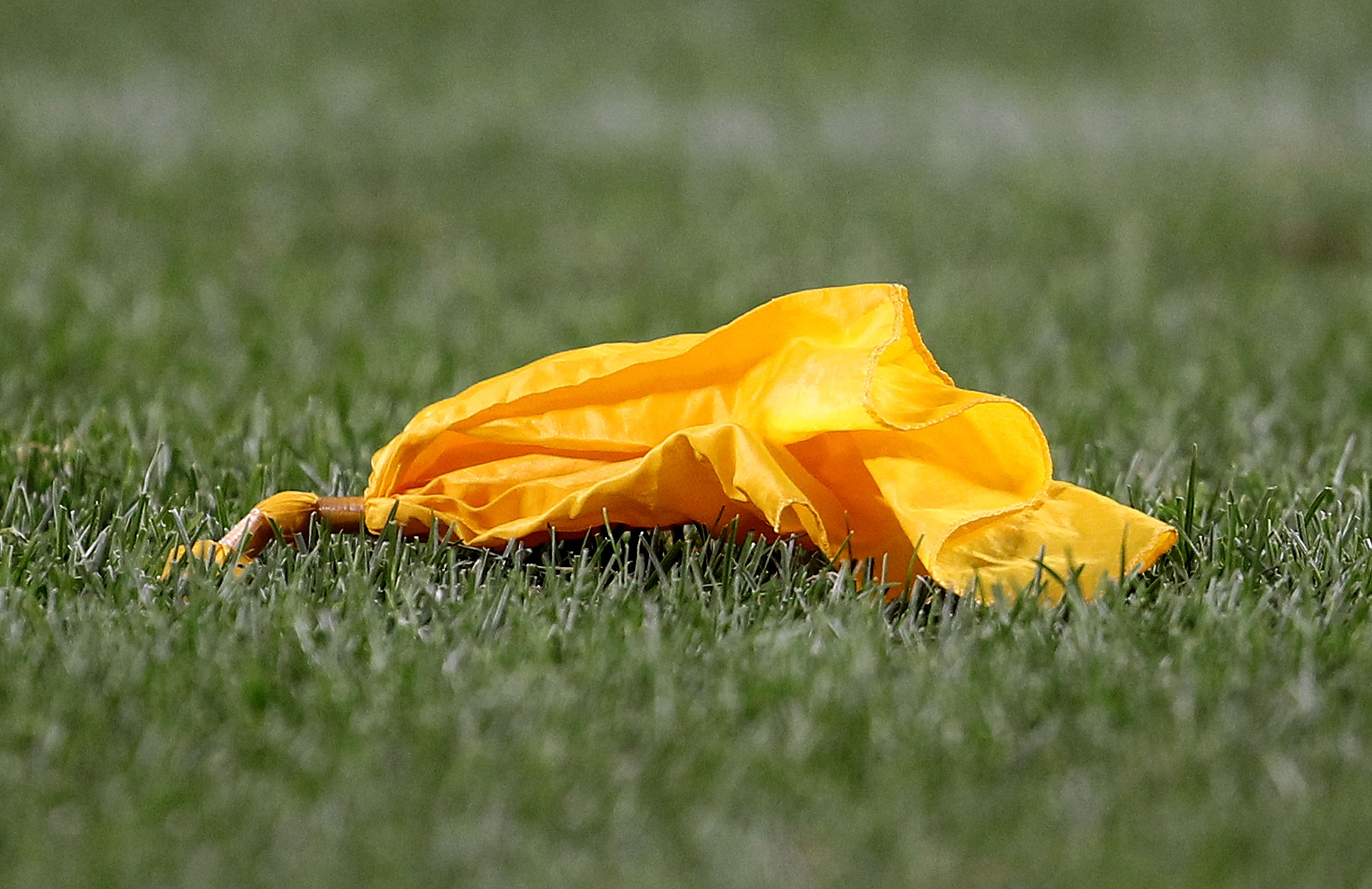 CHICAGO - AUGUST 28: A penalty flag lays on the ground during a preseason game between the Chicago Bears and the Arizona Cardinals during a preseason game at Soldier Field on August 28, 2010 in Chicago, Illinois. The Cardinals defeated the Bears 14-9. (Ph