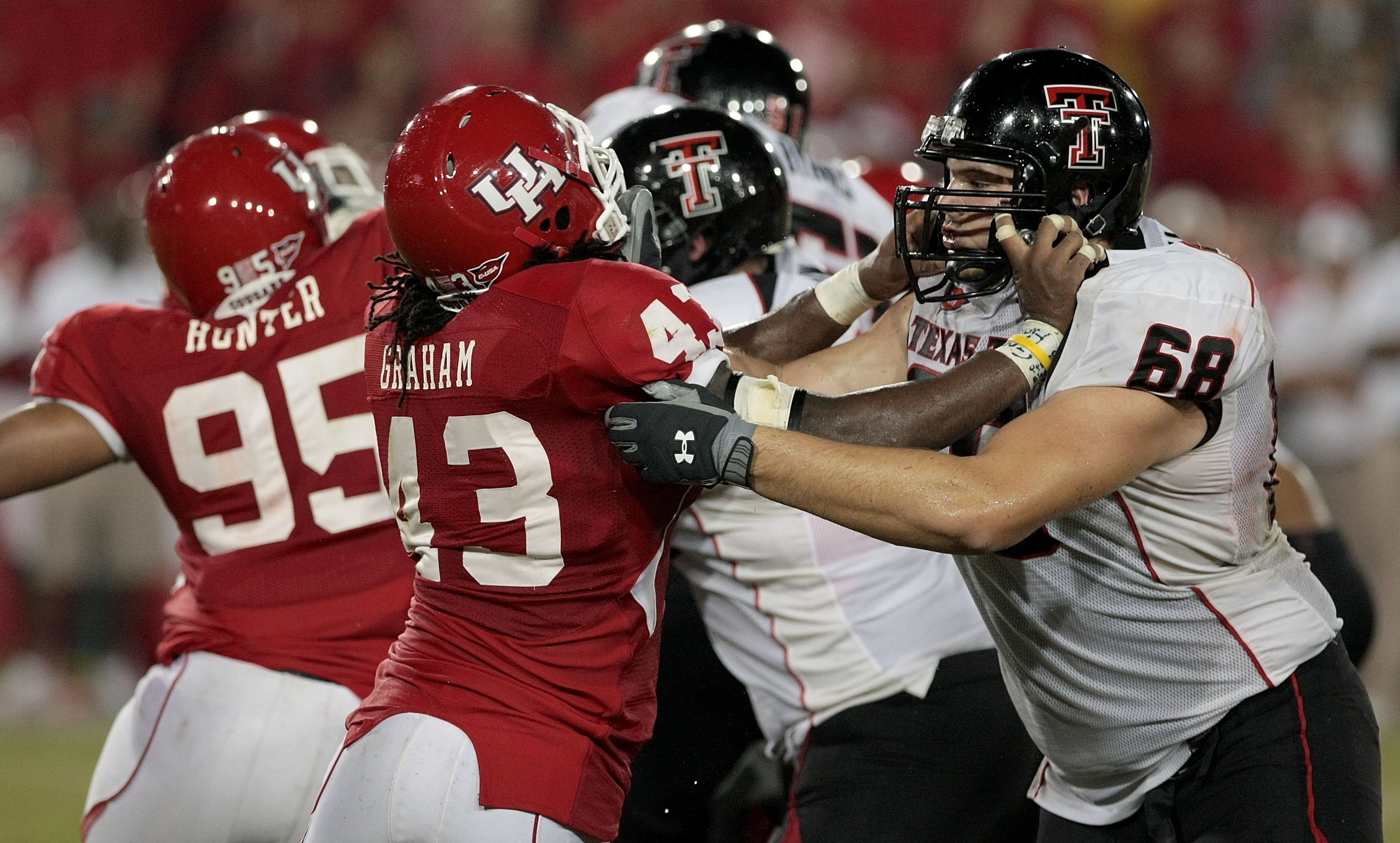 HOUSTON - SEPTEMBER 26: Defensive end Tyrell Graham #43 of the Houston Cougars blocks lineman Terry McDaniel #68 of the Texas Tech Red Raiders at Robertson Stadium on September 26, 2009 in Houston, Texas. (Photo by Thomas B. Shea/Getty Images)