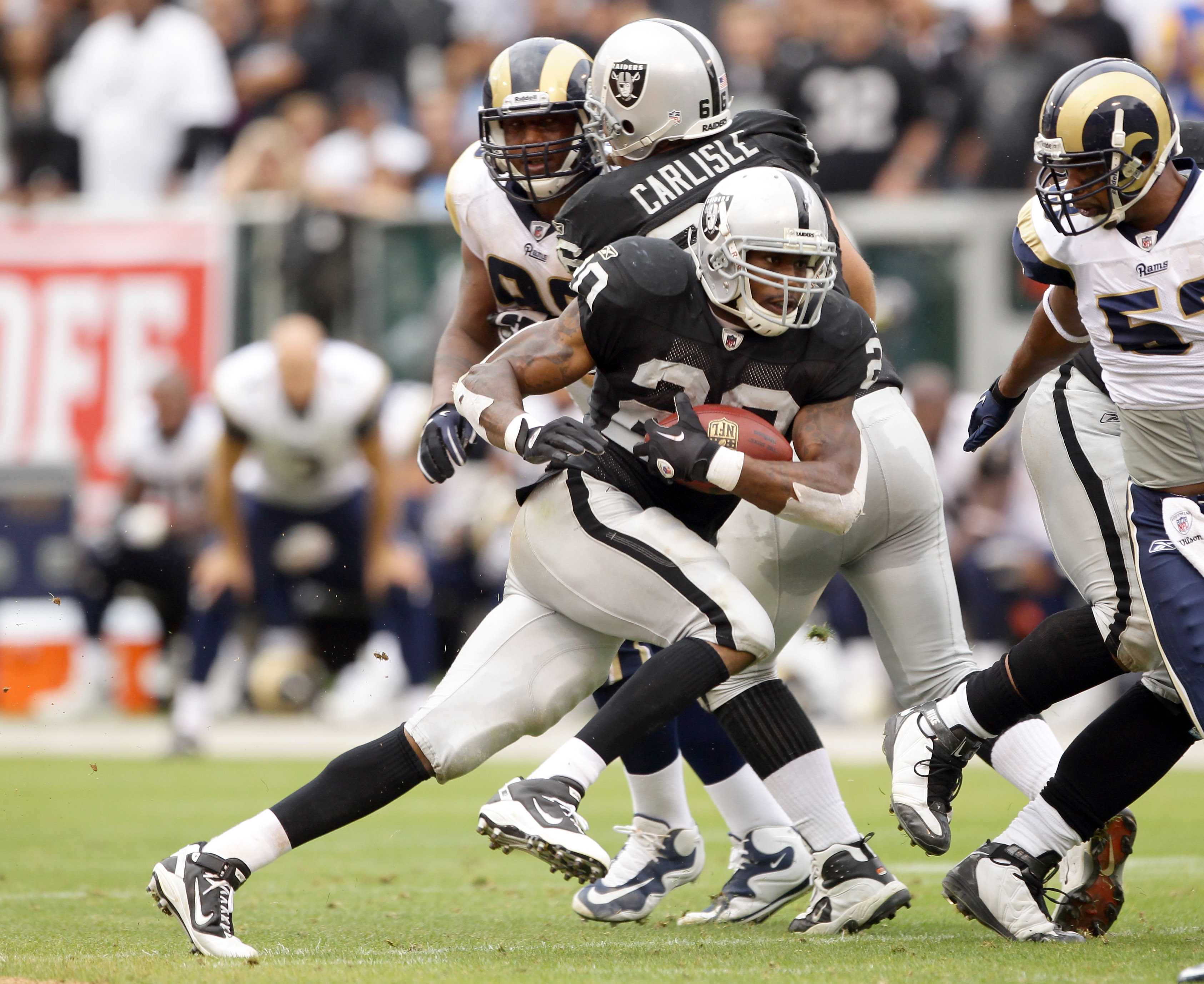 Oakland Raiders running back Darren McFadden (20) pushes off of Kansas City  Chiefs safety Jarrad Page (44) during the first half of an NFL football  game Sunday, Sept. 20, 2009, in Kansas