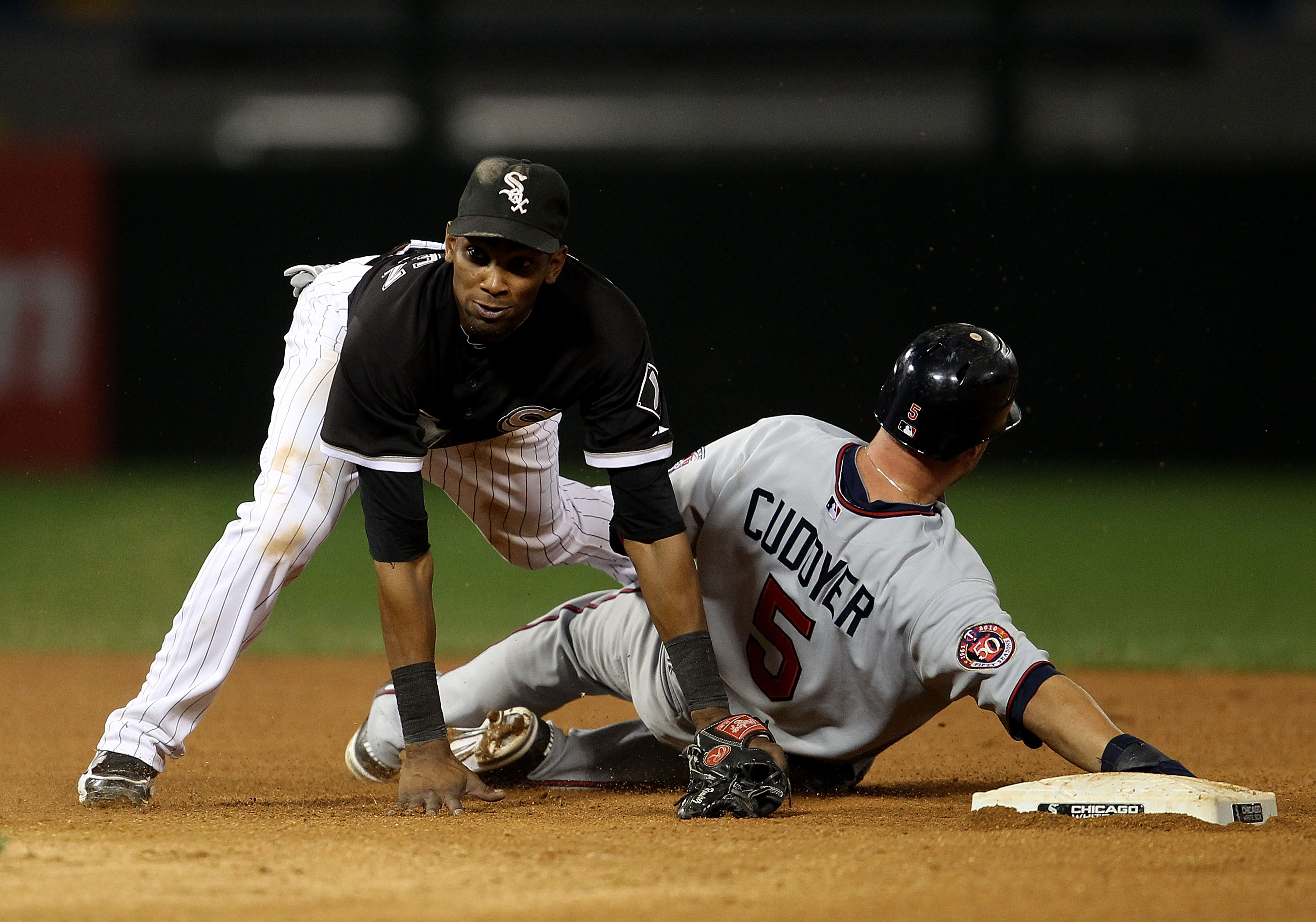CHICAGO - SEPTEMBER 14: Alexei Ramirez #10 of the Chicago White Sox falls over Michael Cuddyer #5 of the Minnesota Twins after turning a double play at U.S. Cellular Field on September 14, 2010 in Chicago, Illinois. (Photo by Jonathan Daniel/Getty Images)